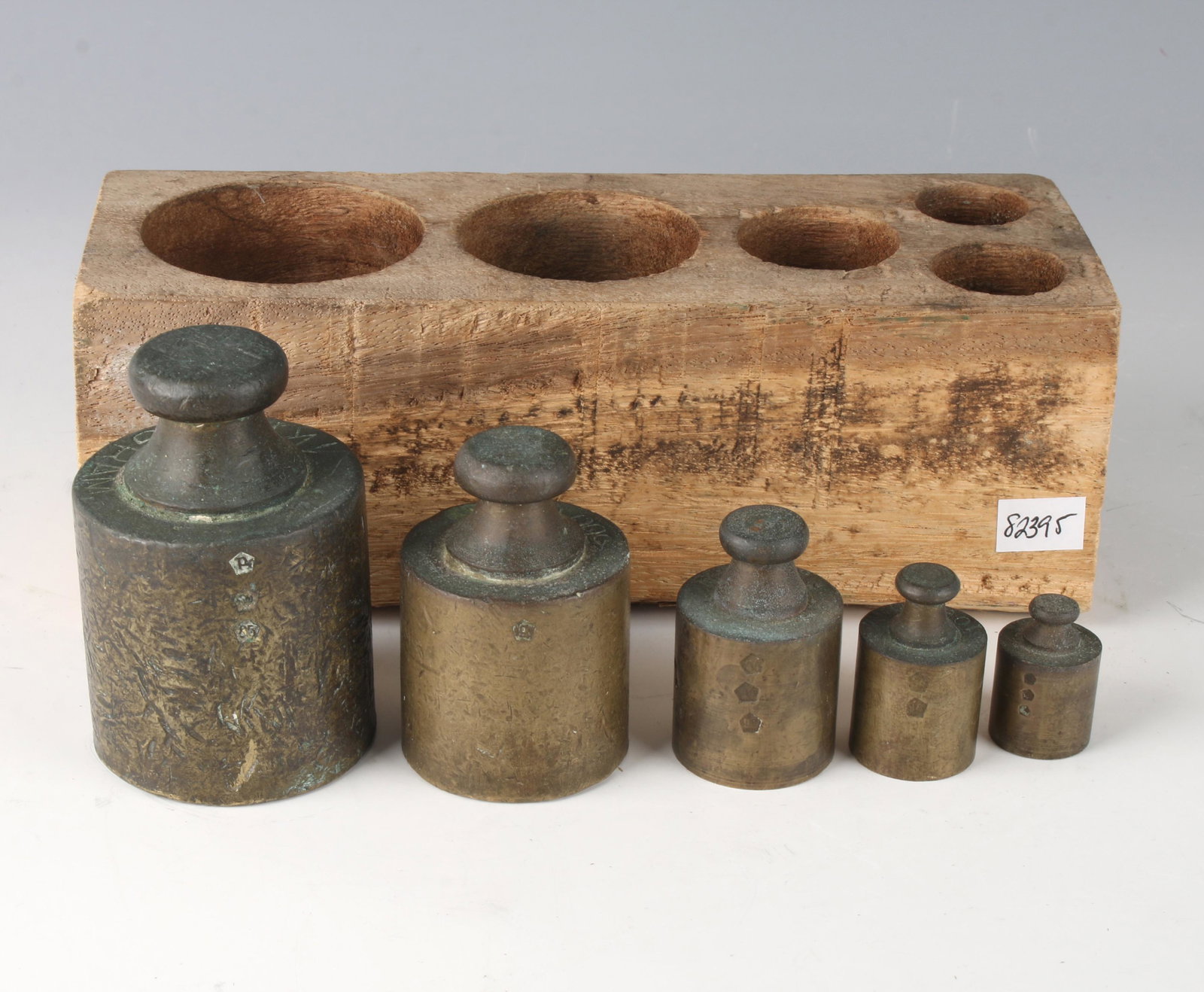 VINTAGE SET OF WEIGHTS IN WOODEN HOLDER: VINTAGE SET OF WEIGHTS IN WOODEN HOLDER: Five weights 1kg, 500g, 200g, 100g, and 50g. All have hallmarks. In wooden storage box. 7 3/4" X 2 3/4" $100 - $2
