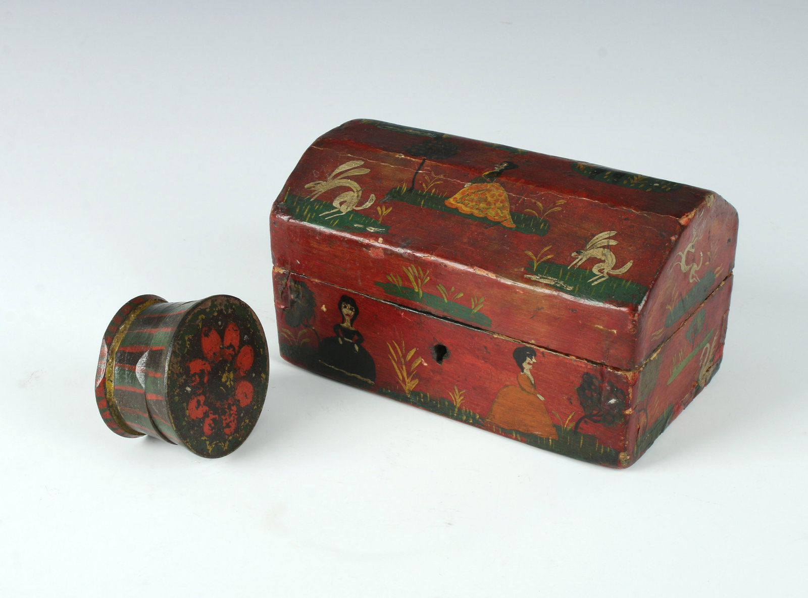 2 CHARMING WOODEN PAINTED FOLK ART BOXES: 2 CHARMING WOODEN PAINTED FOLK ART BOXES: Folk art painted small wooden trunk in distressed condition. A small wooden pillbox with painted flower on top and strips on sides.