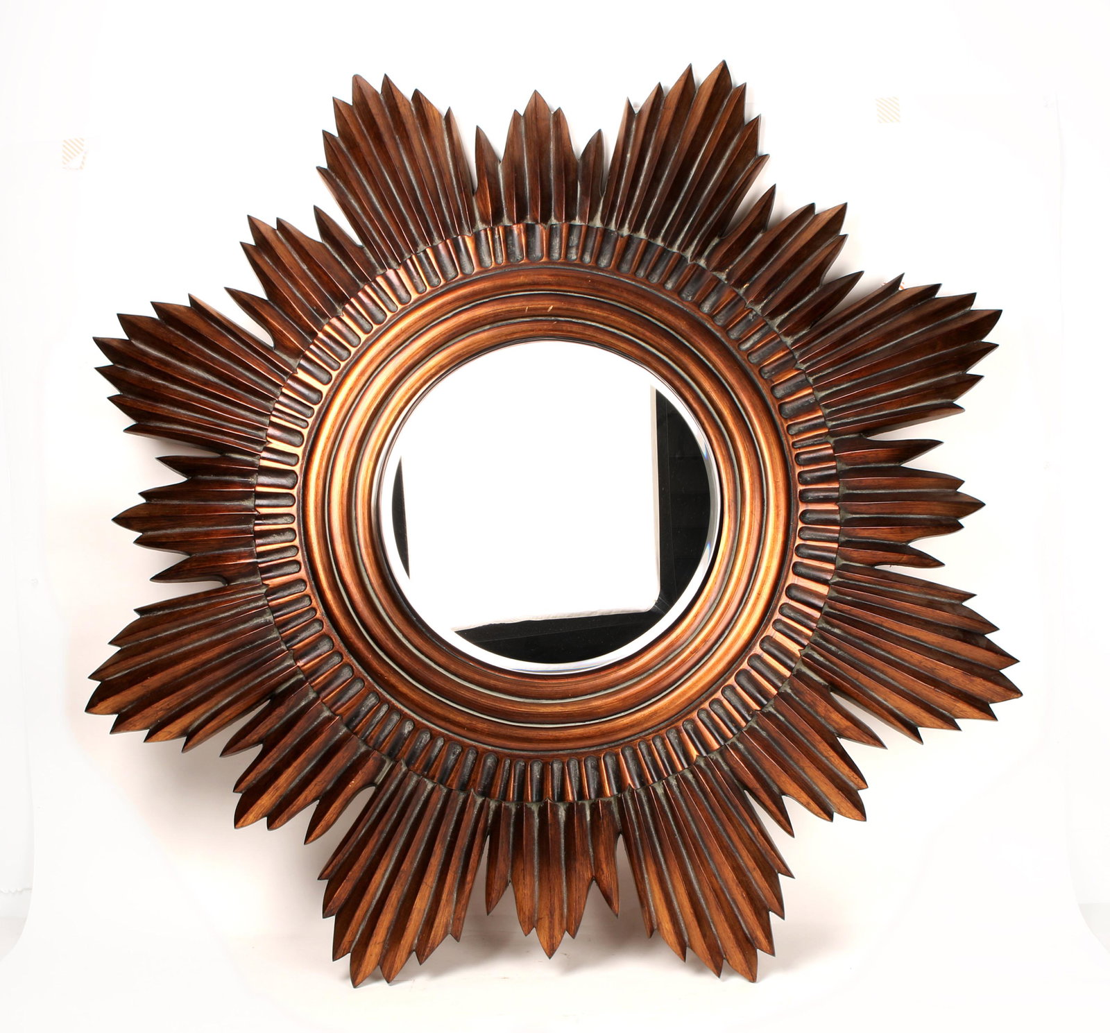 LARGE STARBURST DECORATOR MIRROR: LARGE STARBURST DECORATOR MIRROR: A dramatic decorator item. Howard Elliot Item # 2075. Copper patina resin, beveled glass mirror. 46" $100 - $200 Sh