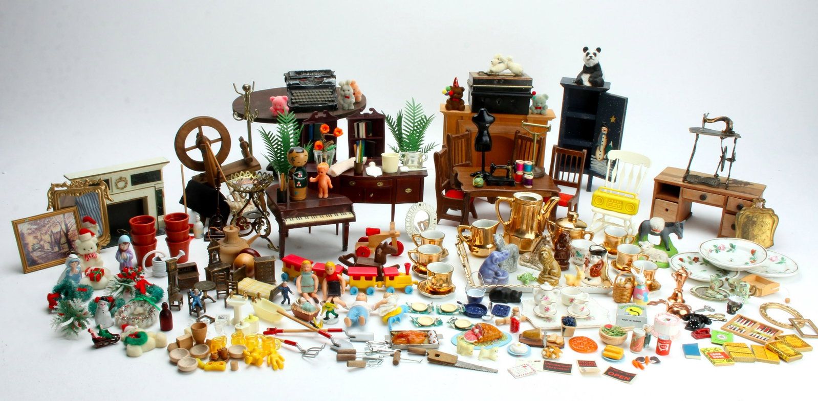 LARGE ASSEMBLED LOT DOLL HOUSE FURNITURE ETC: Mixed lot with luster and other tea sets, Wade Whimsies, gardening tools, books, telephones, spinning wheel, bendable dolls, doll house food, and many other assorted categories. Plastic and wooden dol