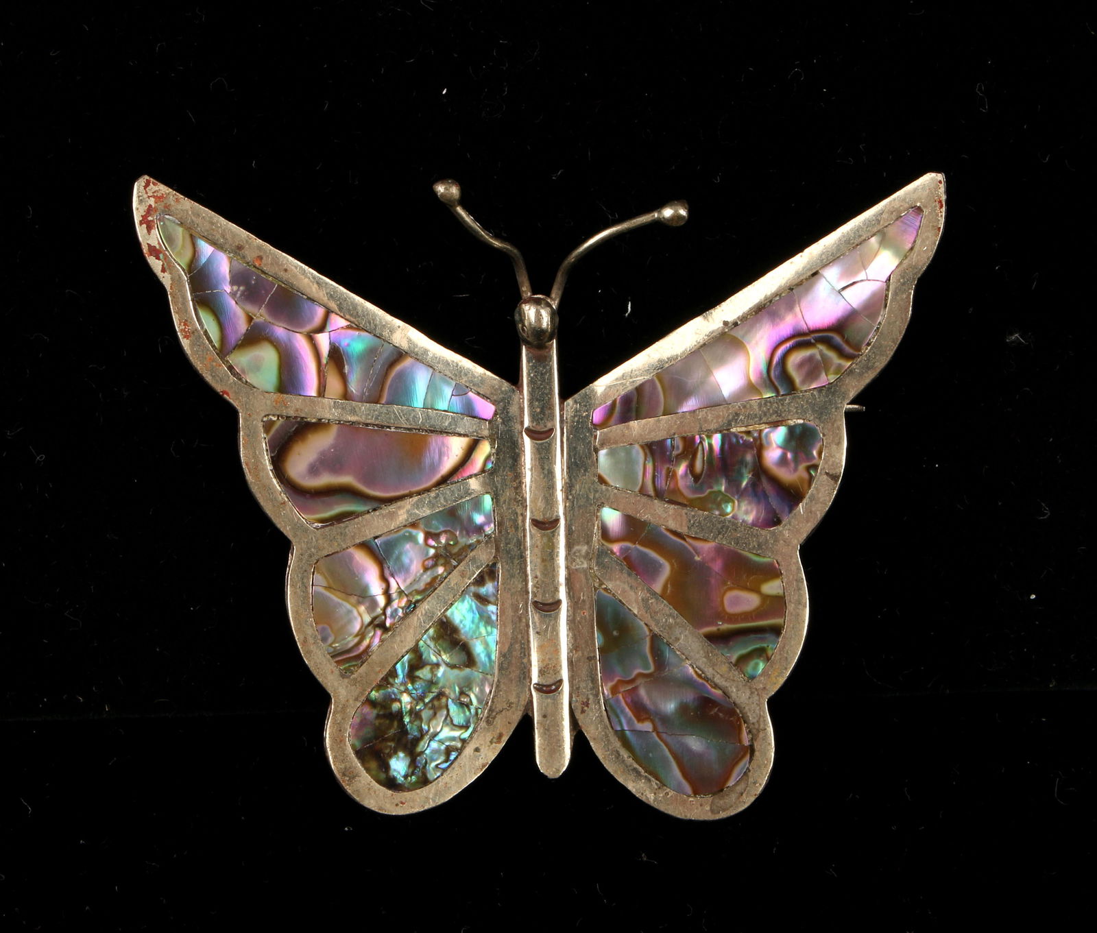 LG VINTAGE MEXICAN STERLING ABALONE BUTTERFLY PIN: Vibrantly colored abalone inlay defines the butterfly wings and incised lines and antennae add detail. 8g. 2 1/2" $50 - $150 Please contact us for high resolu