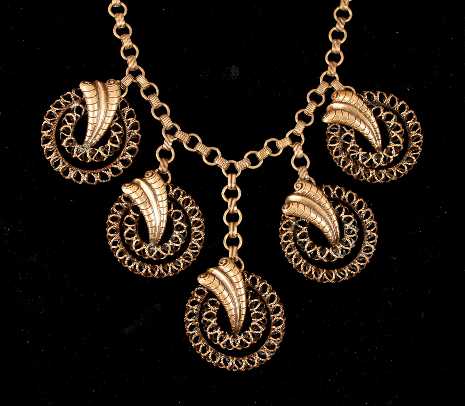FABULOUS 1940S BOOK CHAIN NECKLACE: Large five pendant necklace with wirework circles, stylized leaves, and book chain. A longer central disc and shorter side elements. $200 - $400 Please contact us for high resolution images of this lo
