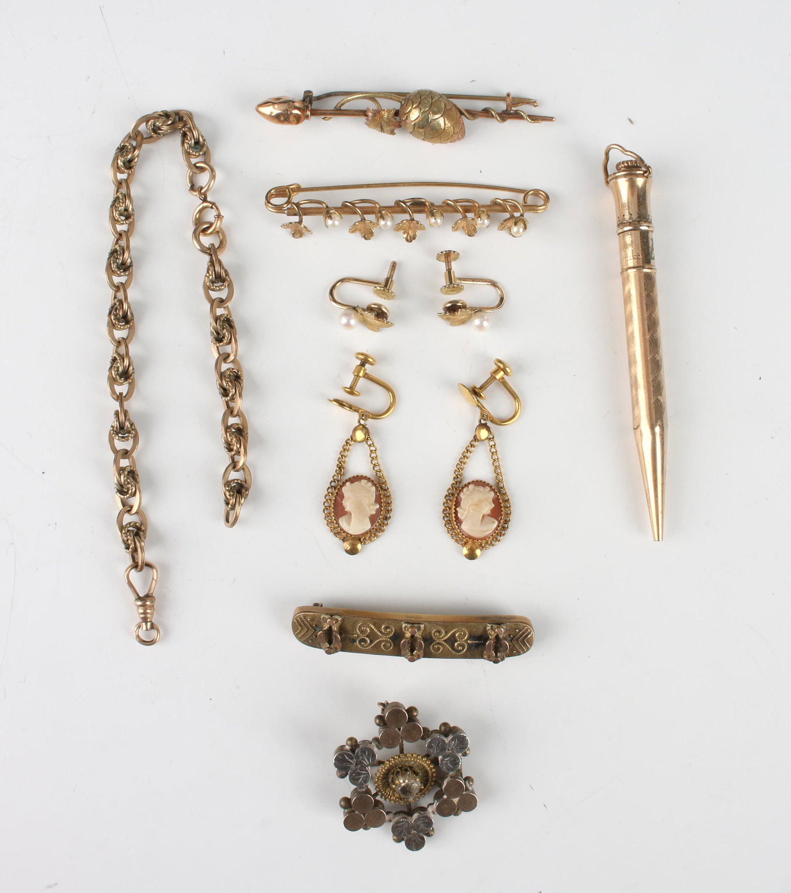 ASSEMBLED LOT VINTAGE ANTIQUE GOLD FILLED ITEMS: Mechanical pencil, three bar pins, pair of cameo drop earrings, circular pin, broken watch chain, and pair of pearl and leaf earrings (one missing screw back). $40 - $80 Please contact us for high res
