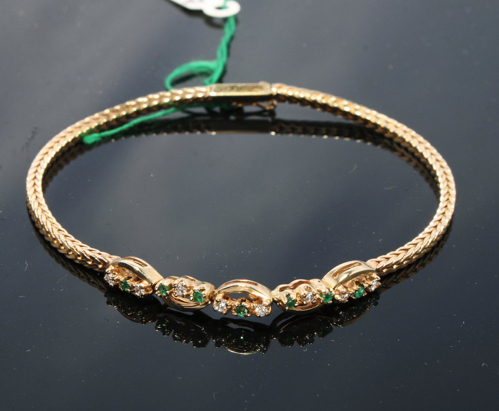 DELICATE DIAMOND & EMERALD YG BRACELET: Delicate emerald and diamond links top a chain bracelet. Alternating emerald and diamond links weave across the top of a fox link chain bracelet. Diamond .16ct.