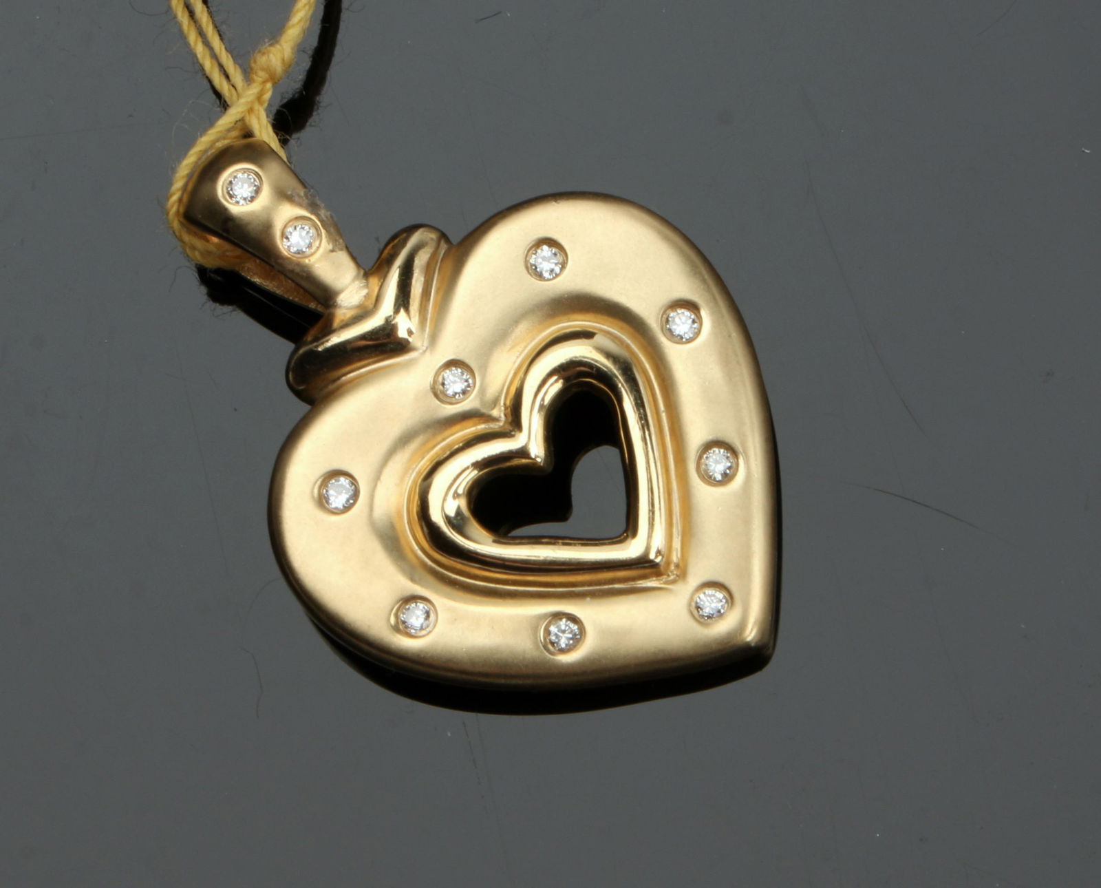 YELLOW GOLD OPEN HEART AND DIAMOND PENDANT: Brushed finish double open heart with 8 small diamonds .07 total carats. New fine jewelry from 2nd generation Texas store retirement sale. All with low reserves