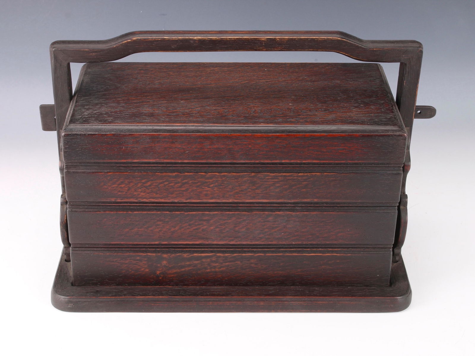 TIERED ZITAN LUNCH BOX: Four tier lunch box with slide lock. The sides of the base are pierced with scrolled ends. 15" X 8 1/4" X 10 1/2" $400 - $600 Please contact us for high resolution images of this