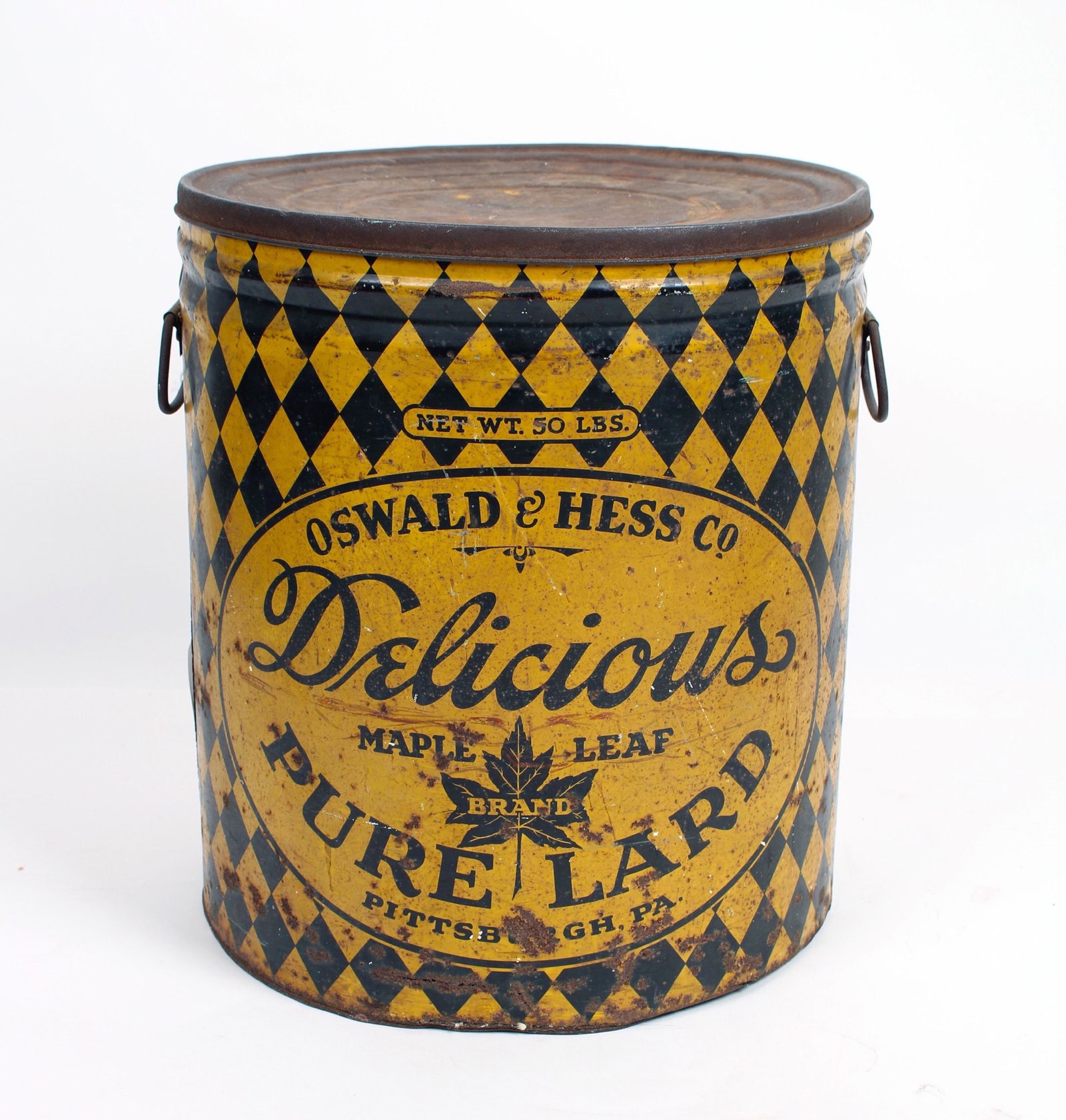 VINTAGE OSWALD & HESS CO. LARGE METAL TIN: Black and yellow diamond pattered lidded tin marked Oswald & Hess Co. Delicious Maple Leaf Brand Pure Lard Pittsburgh, Pa. Wire Handles on the side. 12" X 14" $100 - $200 Please c