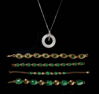 4 JADE BRACELETS & JADE PENDANT NECKLACE: Gold tone metals all set with green cabochon jade stones. The necklace is a ring of white jade, the silver metal is marked 925. $100 - $200 Please contact us for high resolution images of this lot. 