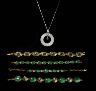 4 JADE BRACELETS & JADE PENDANT NECKLACE: Gold tone metals all set with green cabochon jade stones. The necklace is a ring of white jade, the silver metal is marked 925. $100 - $200 Please contact us for high resolution images of this lot. 