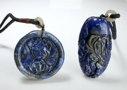 2 SODALITE CARVED PENDANTS: One is an oval, one is a circle. The circular one is carved in a peony with a rope edge. The oval pendant is a luohan with peaches and a crane.  3&quot; $40 - $80 Please contact us for high reso