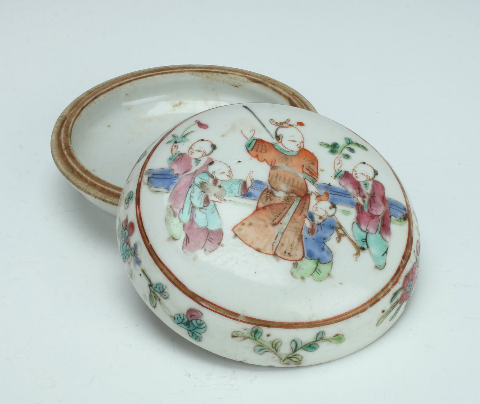 ROUND LIDDED PORCELAIN BOX: The lid is decorated with children celebrating, the edges of the lid and body have floral designs. 4" $100 - $200 Please contact us for high resolution images of this lot. Shipping: