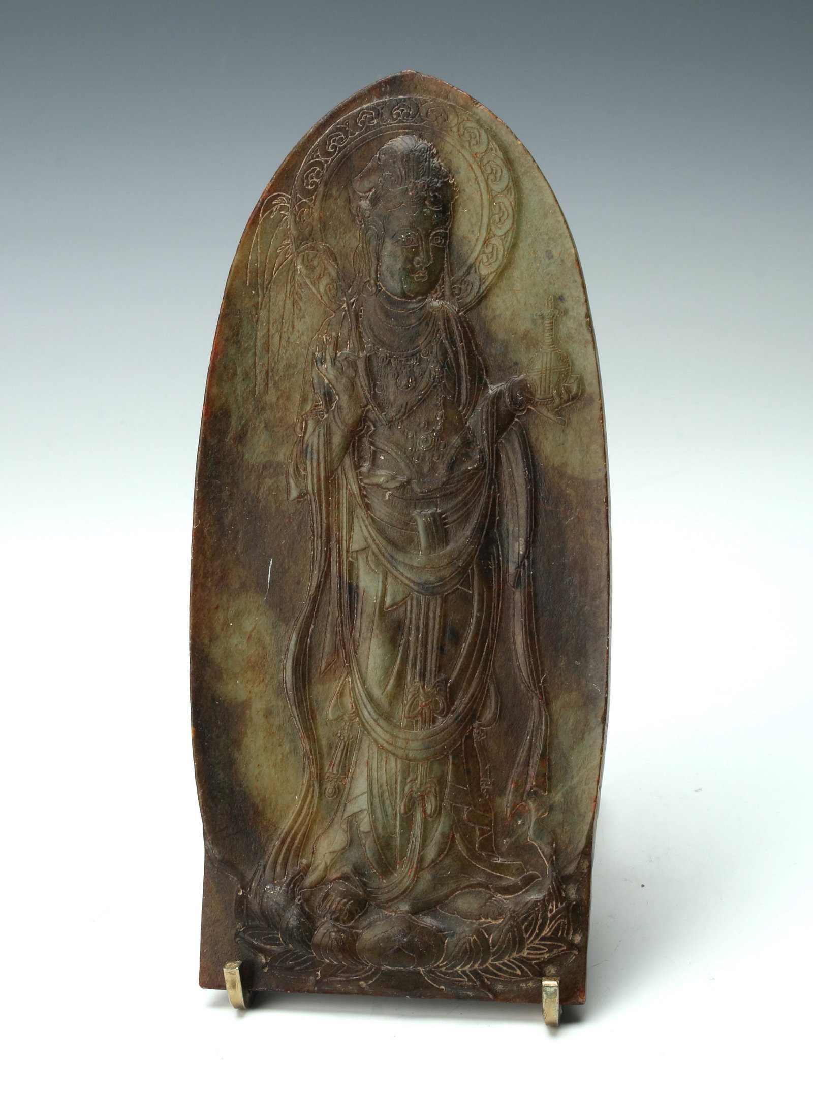 JADE BUDDHA CARVING: Buddha stands on robes holding a bottle and a frond. Standing on a lotus pedestal. 3 1/2" X 7 1/2" $300 - $500 Please contact us for high resolution images of this lot. Shippin