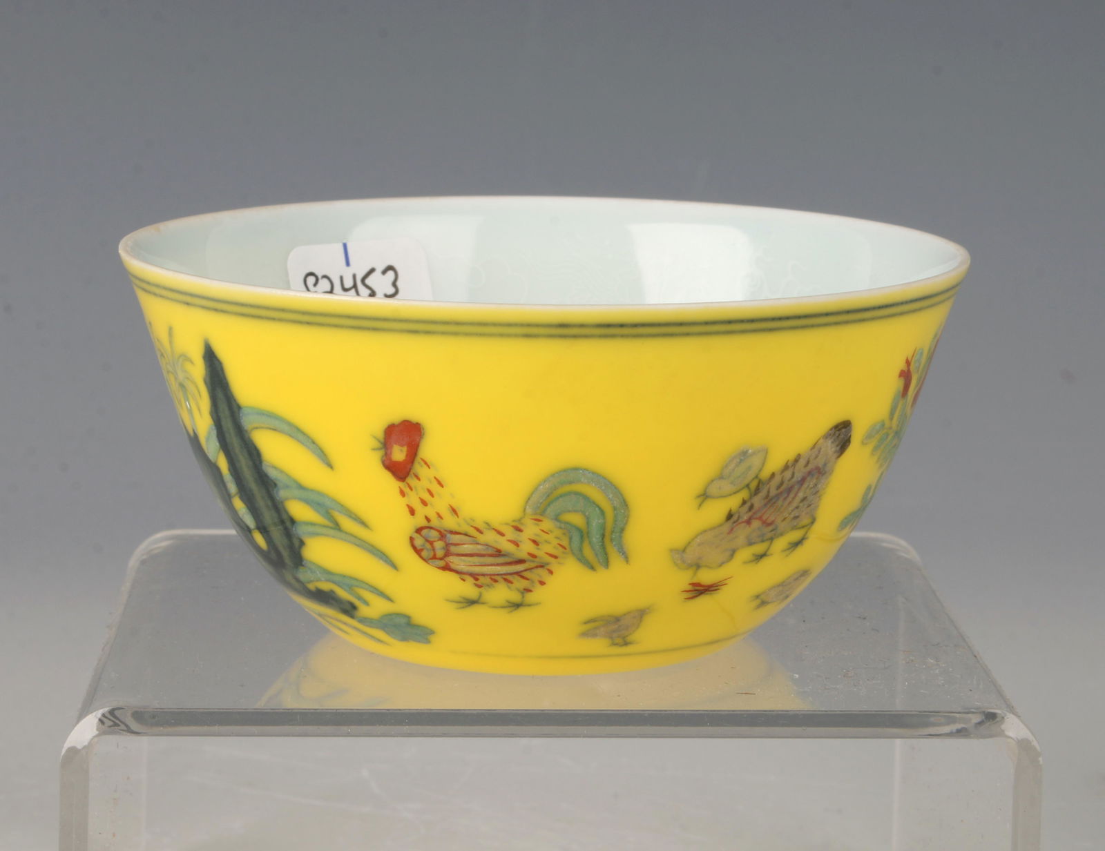 YELLOW ROOSTER THIN PORCELAIN CUP: Glazed yellow on the outside with a rooster, hen, and chicks among boulders. When light shines through cup the delicate designs on the inside are revealed. Marked on the bottom. 3 1/4" X 1 1/2&q