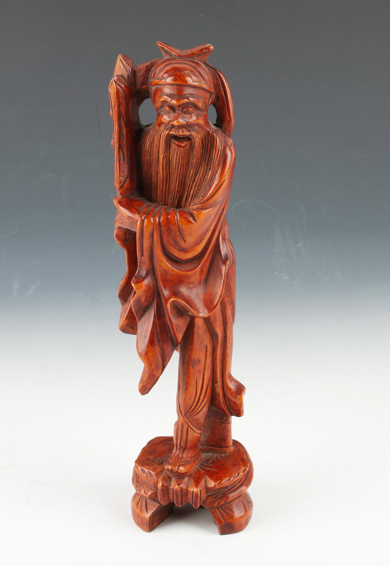 CARVED WOODEN ELDER FIGURE: Long flowing beard and robe. Presenting a vertical piece in his hands. 7" $100 - $200 Please contact us for high resolution images of this lot. Shipping: We a