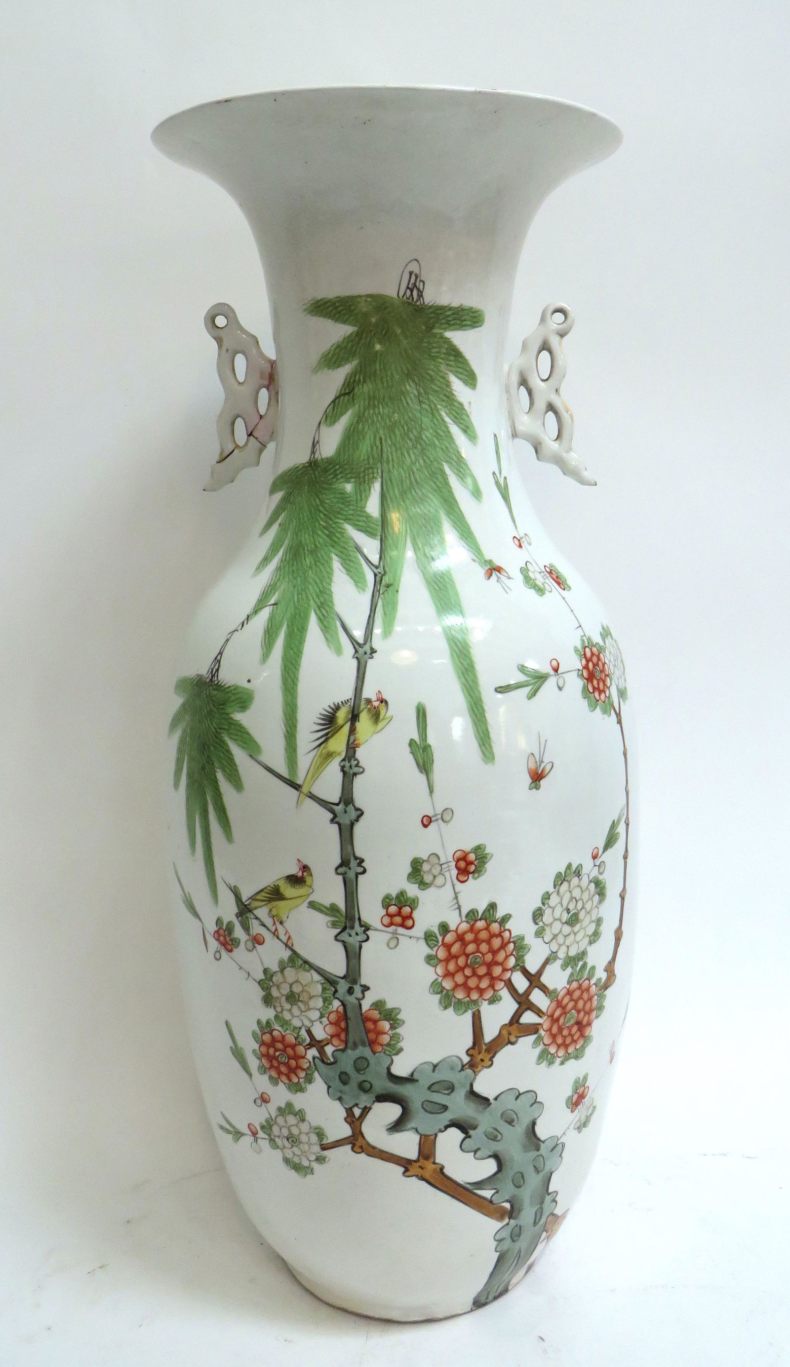 CHINESE PORCELAIN VASE: Tall white baluster vase with flaring neck. Yellow song birds are among orange and white flowers, and bamboo. Calligraphy on back. Has pierced handles. Remnants of seal on the base. 22 1/2" $1