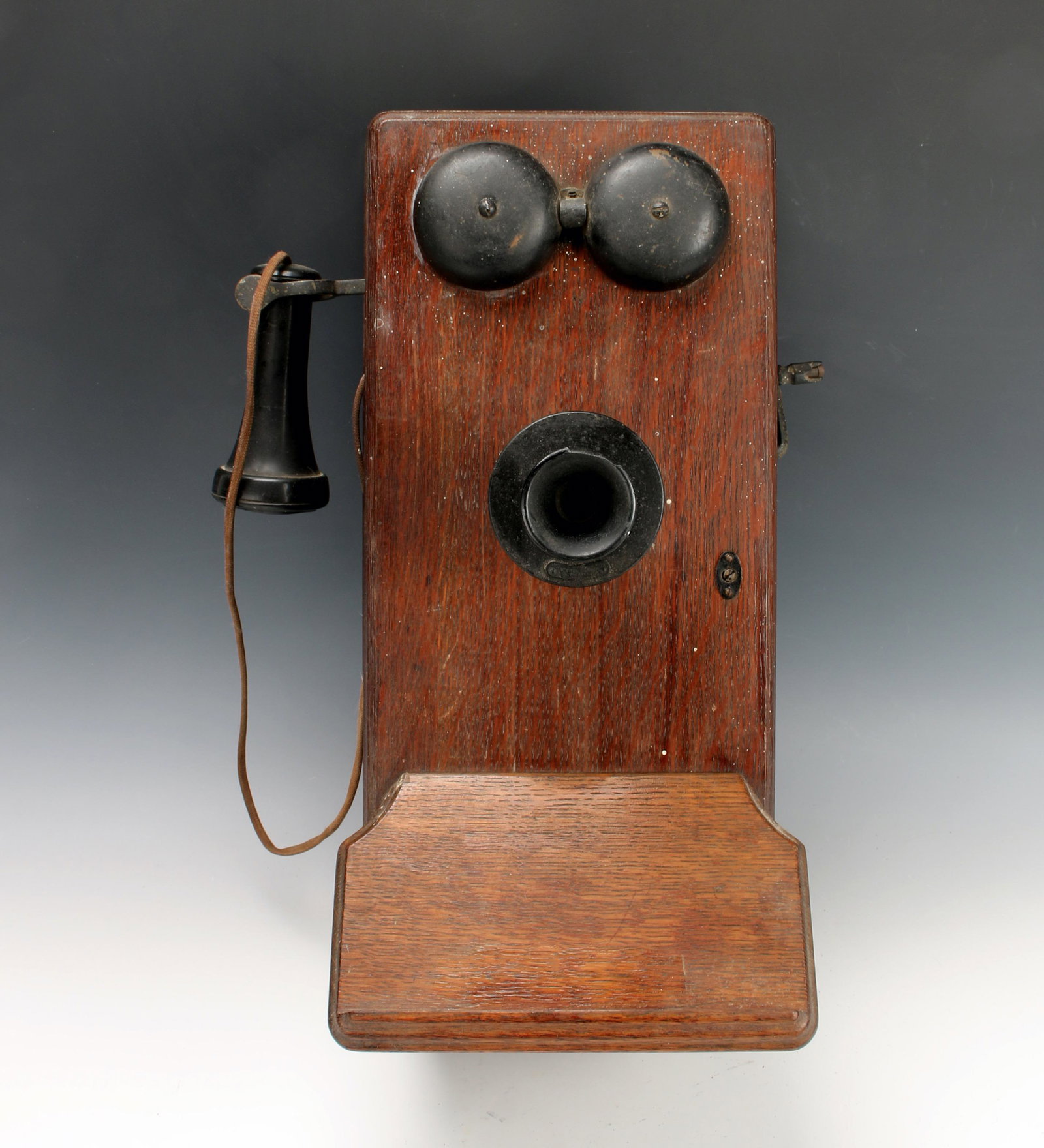 WESTERN ELECTRIC ANTIQUE WALL PHONE C. 1900: Heavy piece with wood case and metal attachments. Crank ringer and mouthpiece. 9" X 20 1/2" $100 - $200 Please contact us for high resolution images of this lot. Shipping:
