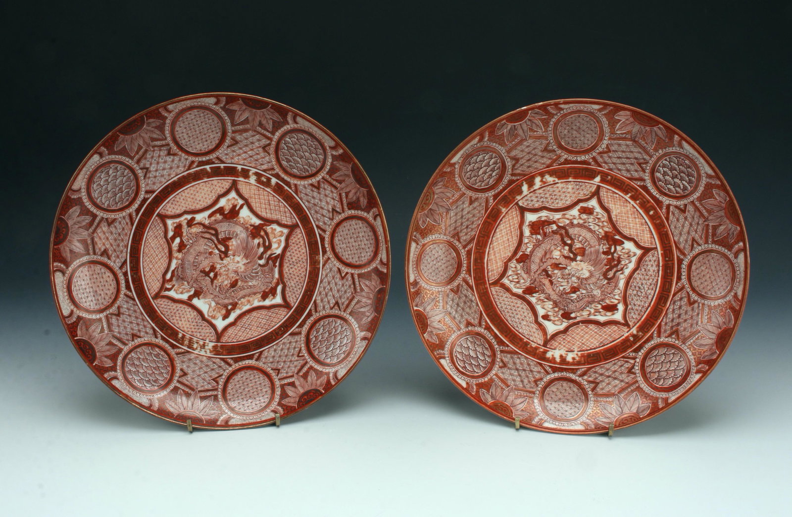 2 JAPANESE DRAGON PLATES: Cinnabar colored roses with gold accents. One dish has more wear than the other. Marked on the bottom. 9 1/2" X 1 1/2" $100 - $200 Please contact us for high resolution images of this