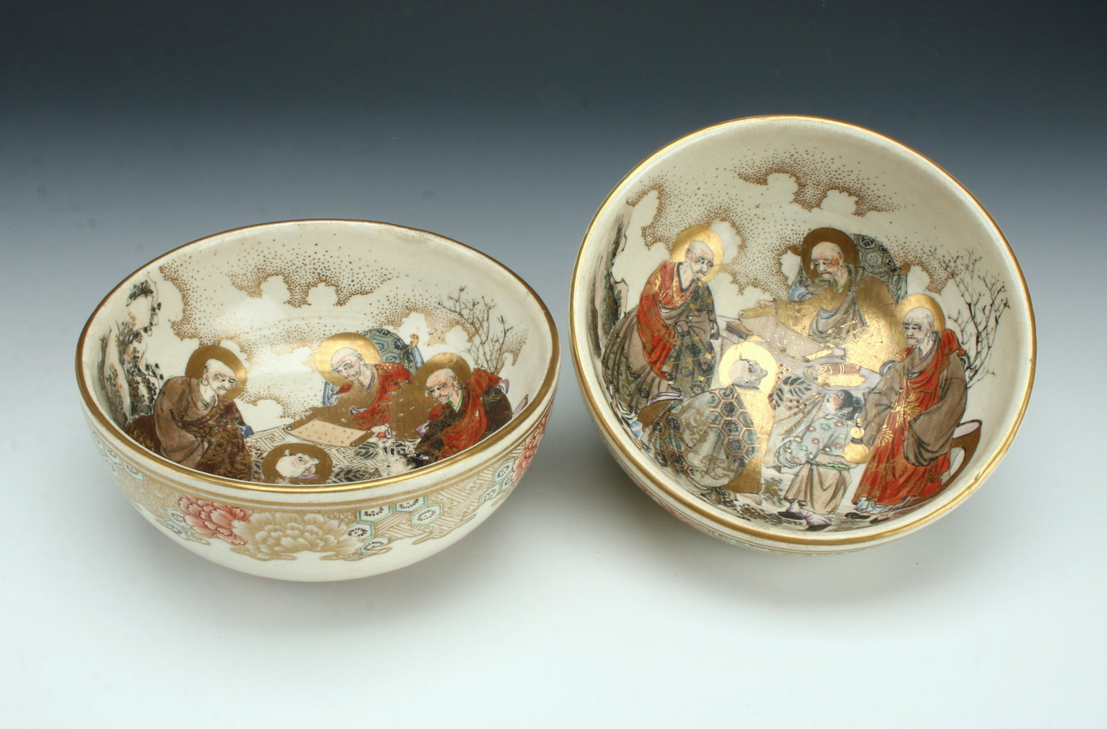 2 PORCELAIN SATSUMA BOWLS: Four scholars are in a garden studying a scroll with trees and clouds around them. The outer borders have complex patterns of hexagonals and flowers. 2 3/4" X 6 1/2" $100 - $200 Pleas