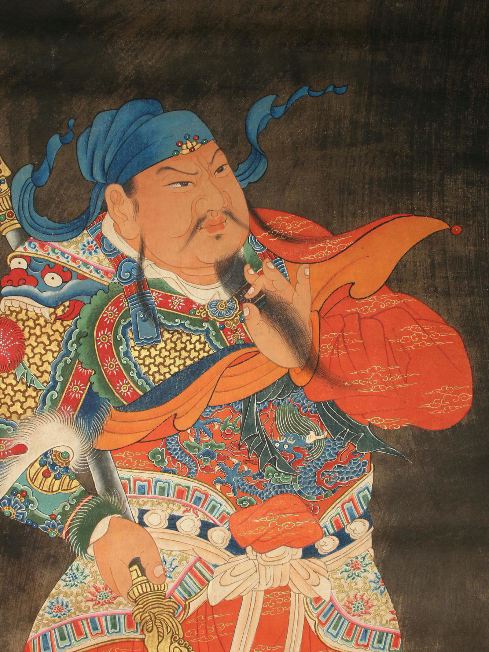 ELABORATELY DETAILED WARRIOR PAINTING: Elaborately painted warrior stroking his beard with one hand and hold a dragon headed sword with the other. Wearing embroidered robes and boots. Brightly colored, extremely detailed, unmounted.