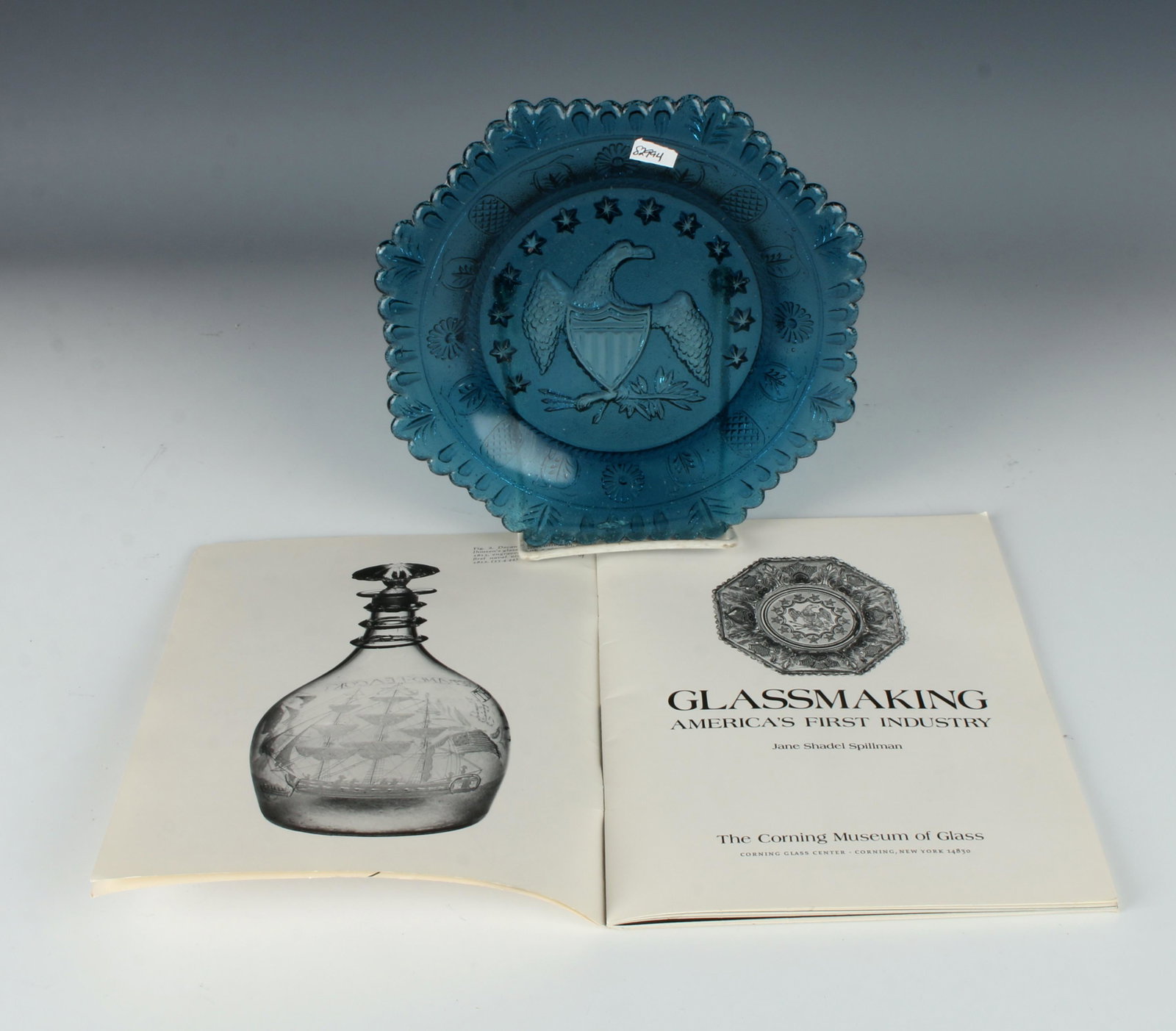 PRESSED GLASS EAGLE PLATE: Includes book on glass making. 8" $40 - $80 Please contact us for high resolution images of this lot. Shipping: We are able to pack and ship this item to an a