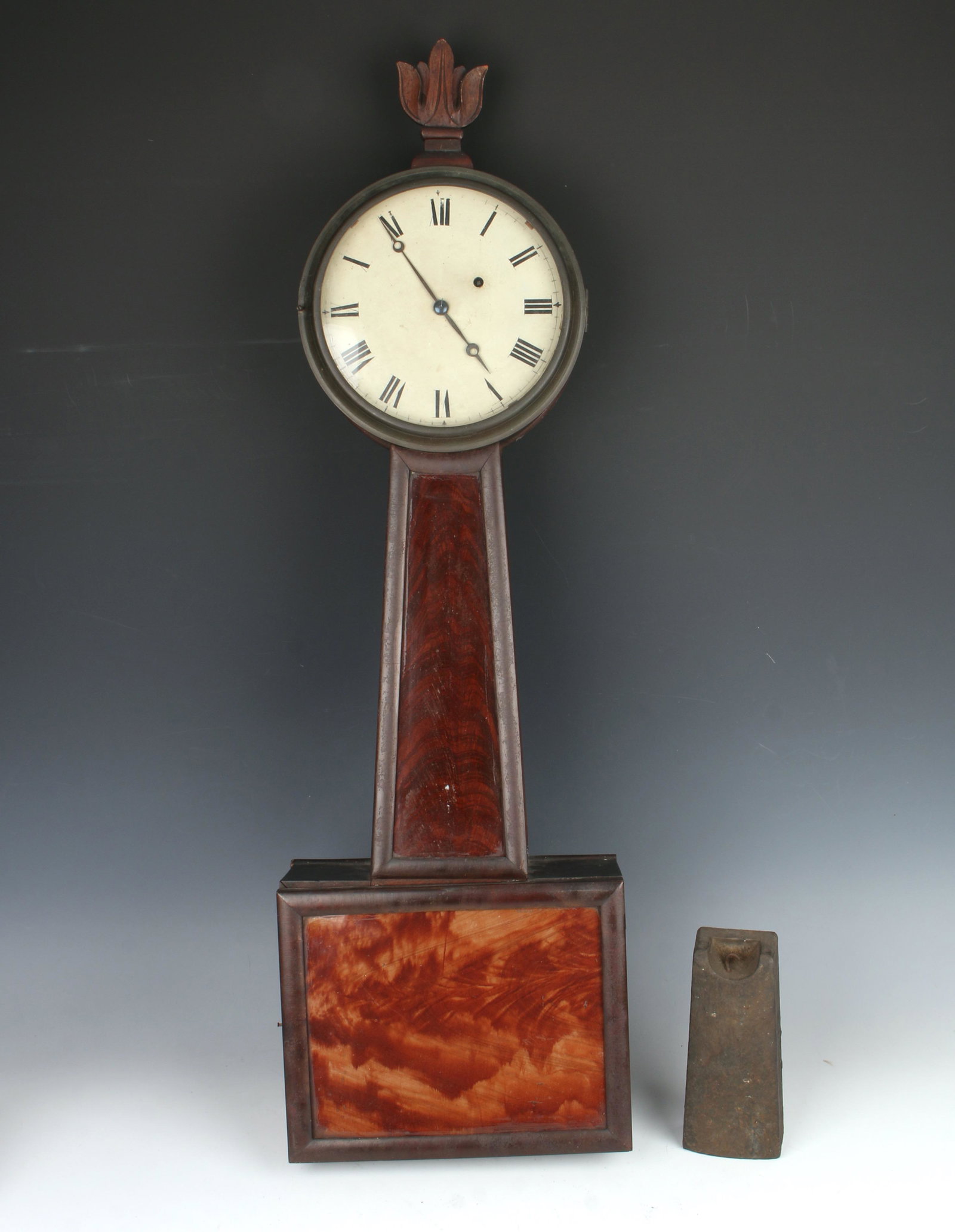 NEW HAMPSHIRE BANJO CLOCK: The glasses are reverse painted in grain patterns. 30" X 10" $1000 - $1500 Please contact us for high resolution images of this lot. Shipping: We are una