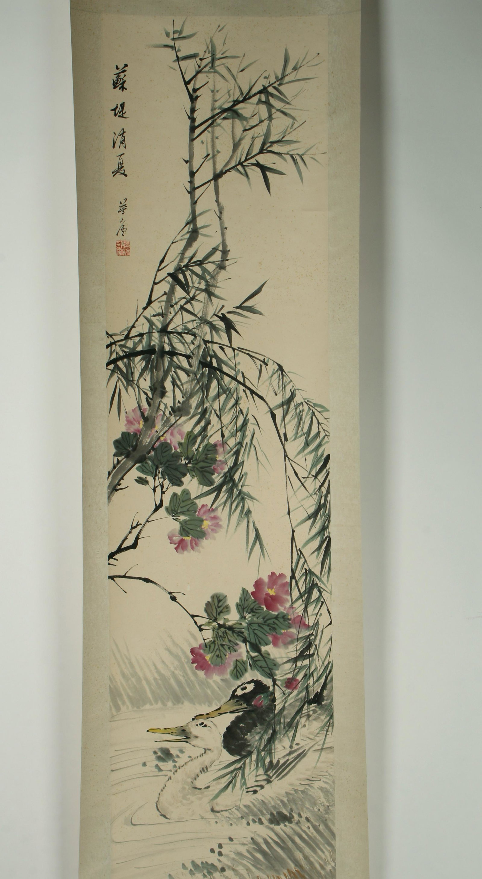 SCROLL OF DUCKS IN WADING IN WATER: Two ducks wade in the water under purple flowers and bamboo. Calligraphy and artist mark on left. Provenance: private local collection.