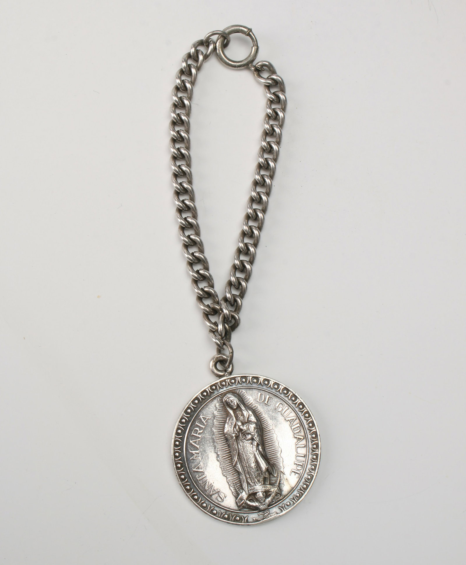 ST. MARIA DE GUADALUPE BRACELET: Bracelet with pendant of St. Maria De Guadalupe. 6" $40 - $80 Please contact us for high resolution images of this lot. Shipping: We are able to pack and ship