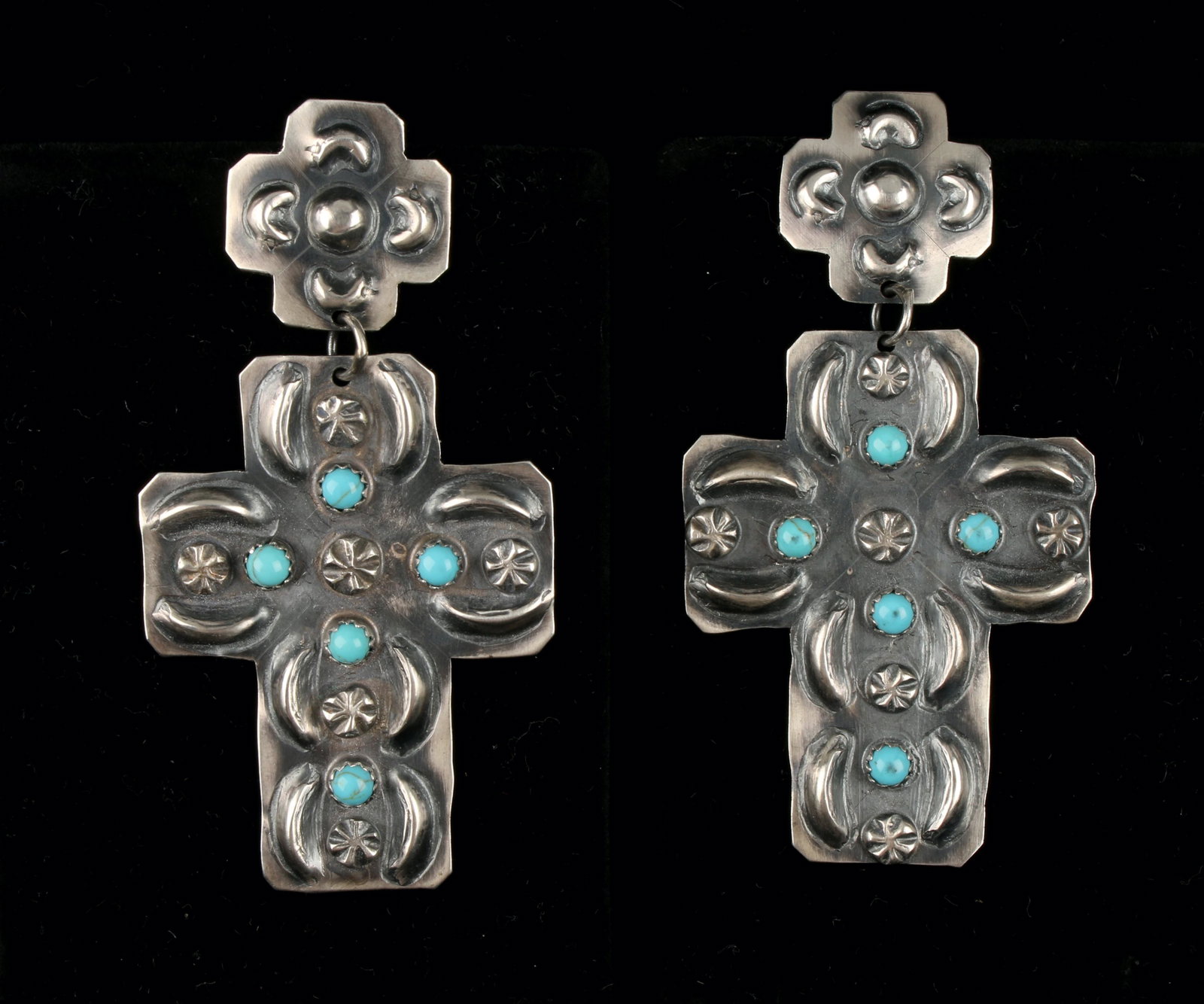 VINTAGE NATIVE AMERICAN TURQUOISE CROSS EARRINGS: Fabulous large handmade Native American cross earrings signed T. Yazzie Sterling. Each earring is prong set with five turquoise stones. With repoussé moon and star patterns. 1 1/2"