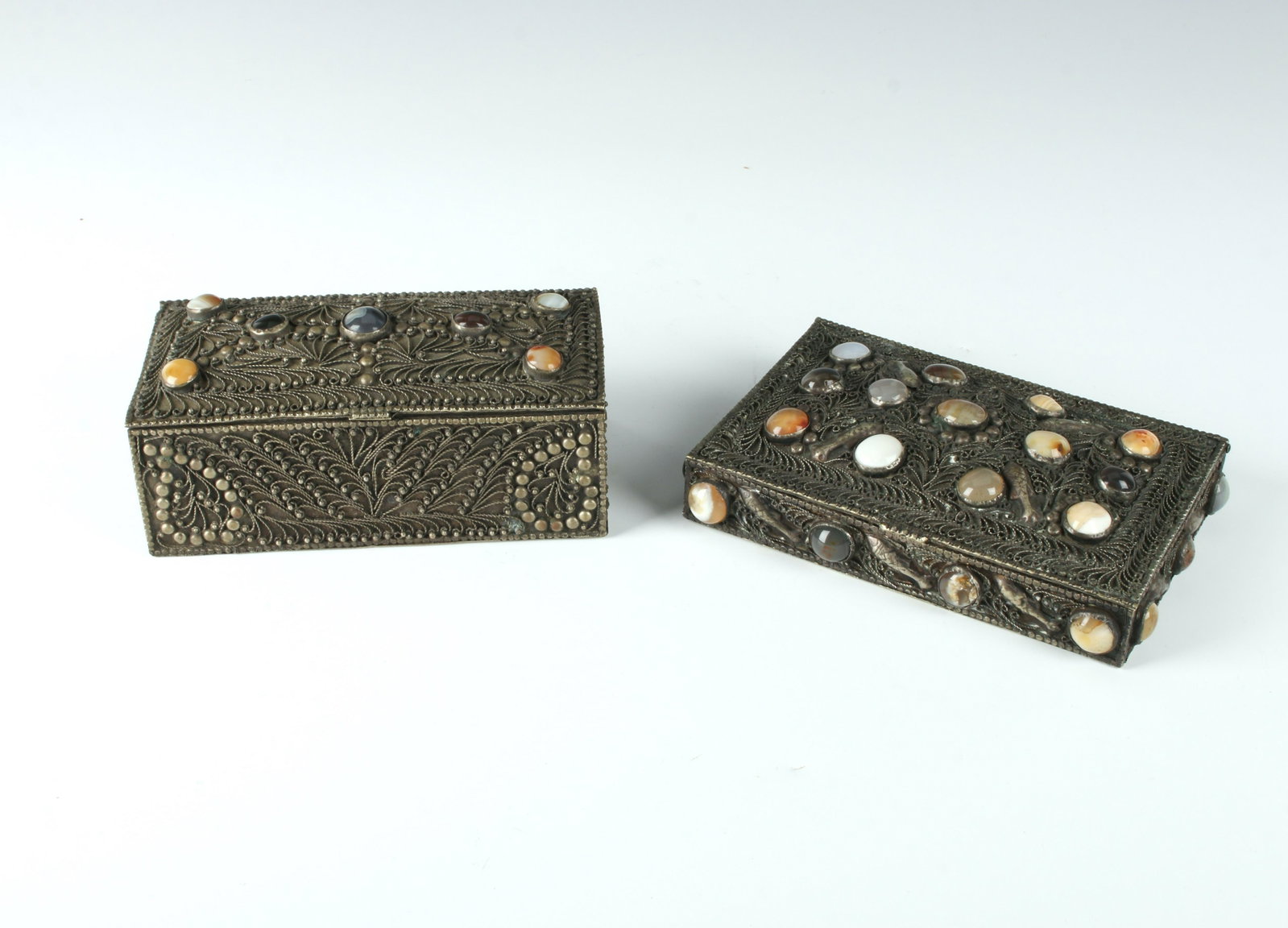 2 MIDDLE EASTERN WIRE WORK & AGATE BOXES: Wire work and agate decorated boxes with elaborate decoration in swirls and applied fish with bezel set agate stones. The flat box with fish has applied metallic quilted fabric inside. 6" X 3&quo