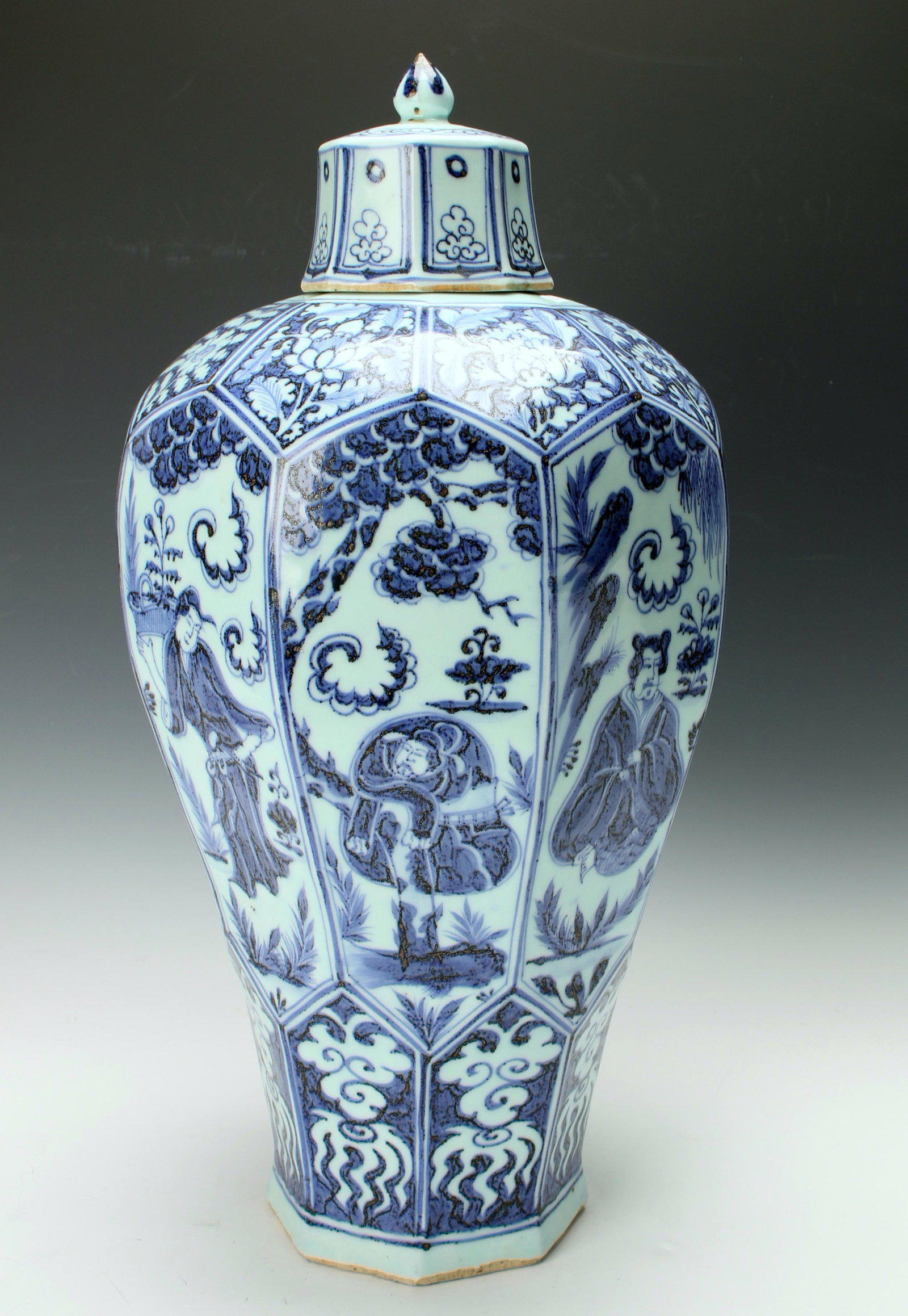 LARGE BLUE & WHITE FACETED LIDDED MEIPING: Octagonal vase with a man in a garden on each panel. The shoulders have flowers. 9 1/2" X 19" $400 - $600 Please contact us for high resolution images of this lot. Shipping: