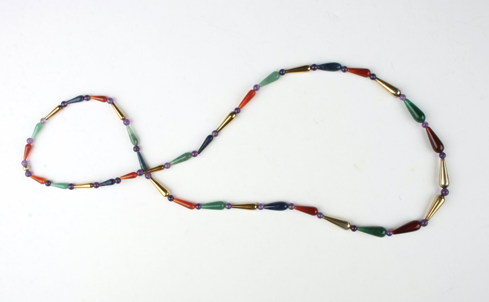 JADE LAPIS CARNELIAN BEAD NECKLACE: Jade, lapis, and carnelian tear drop beads with spacers in between. 32" $40 - $80 Please contact us for high resolution images of this lot. Shipping: We are ab