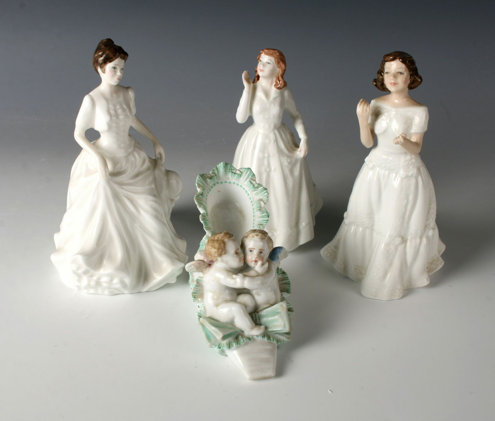 MEISSEN CHERUBS SLIPPER, ROYAL DOULTON FIGURINES: A Meissen slipper figurine with 2 cherubs nestled inside and the crossed sword mark. Three Royal Doulton from 1995, 1996, 1997 of Welcome, Joy, and Harmony. 4" $40 - $80 Please contact us f