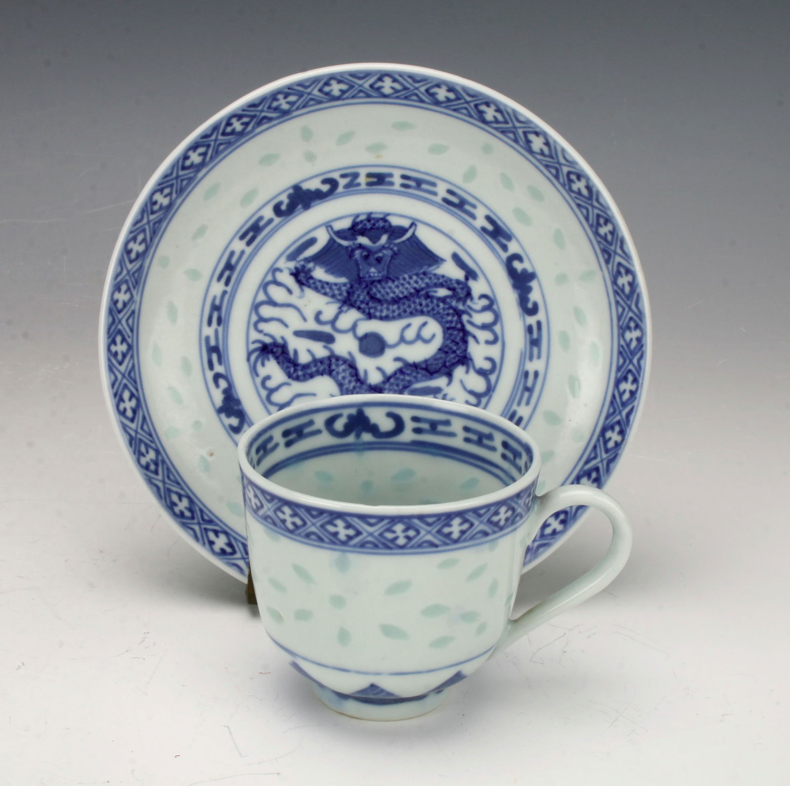 BLUE & WHITE DRAGON CUP & SAUCER: Rice pattern with dragon designs. 4 3/4" $40 - $80 Please contact us for high resolution images of this lot. Shipping: We are able to pack and ship this item t