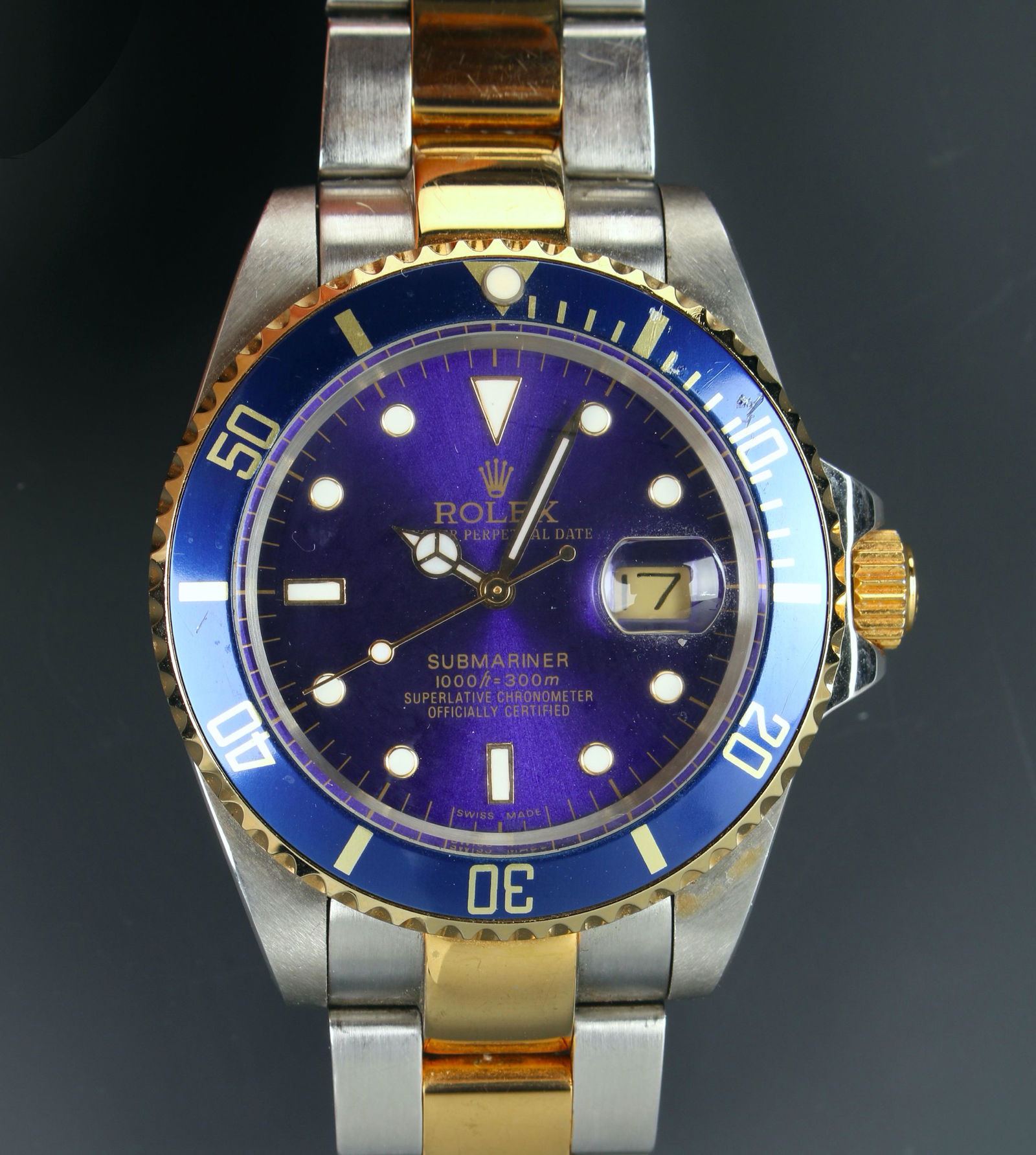 ROLEX OYSTER SUBMARINER LUXURY WATCH: Rolex oyster perpetual date submariner chronometer. Two tone band is marked Rolex Steelimox 62523H 18 D12. Blue dial, dot and index hour markers, solid 18k Rolesor yellow gold bezel with blue cerachro