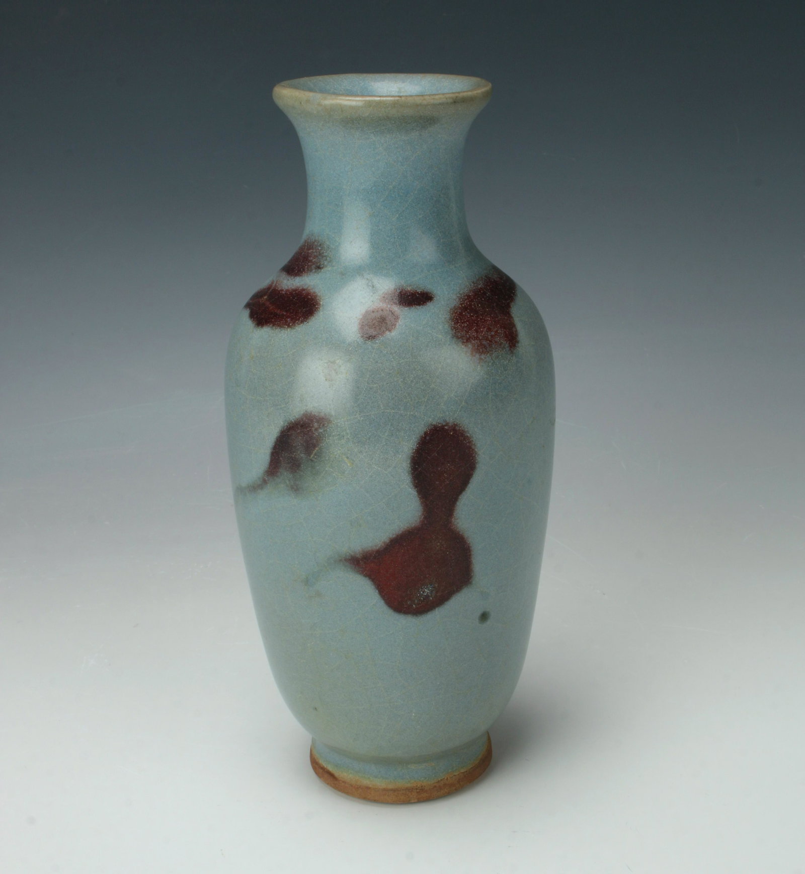 SMALL JUN WARE VASE: All over craquelure glaze on soft blue with ox blood colored markings. Unglazed bottom and foot. 3 1/2" X 7" $300 - $500 Please contact us for high resolution images of this lot. <