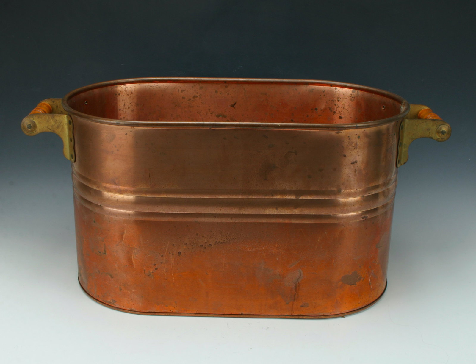 LARGE COPPER LAUNDRY BEVERAGE TUB BUCKET: Riveted brass handles with wooden grips. Perfect for back yard BBQs! 27 1/2" X 12" $40 - $80 Please contact us for high resolution images of this lot. Shipping: