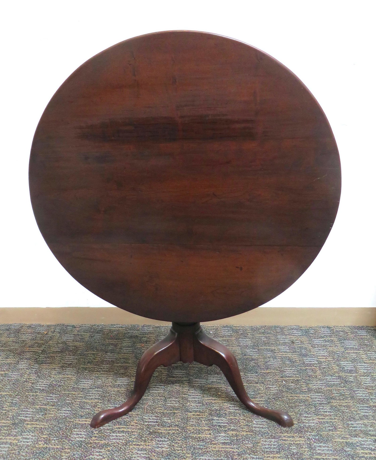 18TH OR 19TH C TILT TOP TEA TABLE: American, in solid walnut with a central turned baluster and snake feet. 46 1/2" in diameter $100 - $200 Please contact us for high resolution images of this lot. Shipping: <