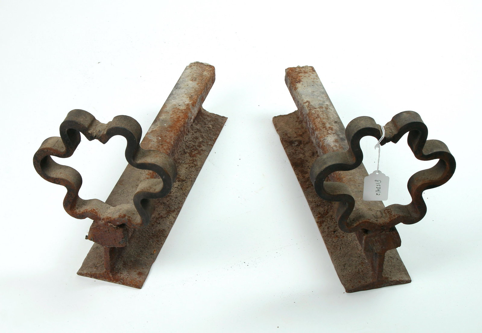 2 FOLK ART RAILROAD TRACK ANDIRONS FIREDOGS: Forged from railroad track with an open flower form on top and space for logs to rest across the ties. Hand forged. Provenance: Purchased in Ashville, NC. 19" X 11" $100 - $200