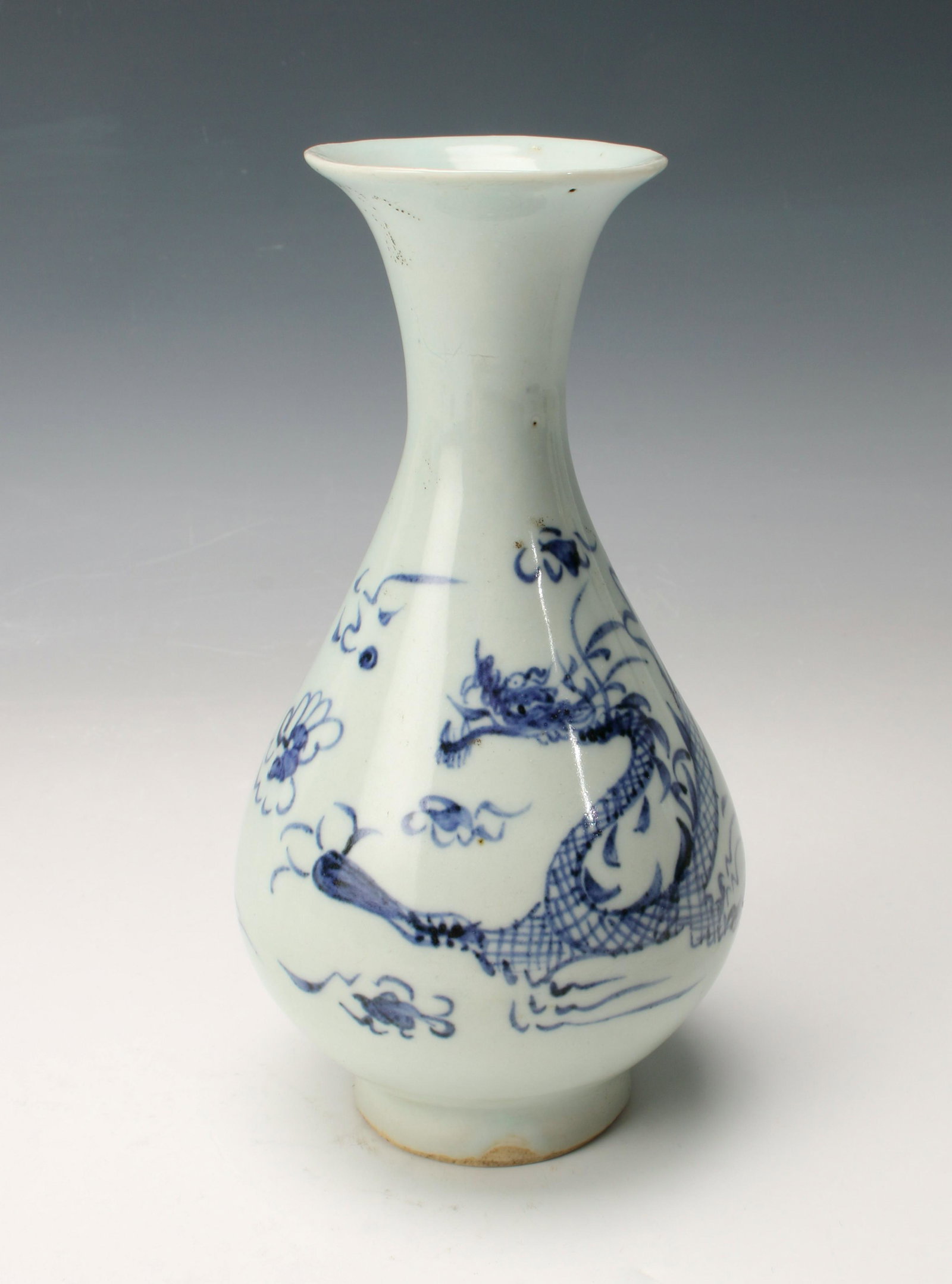 KOREAN DRAGON VASE: Graceful form with a narrow neck and cobalt drawing of a dragon flying among the clouds. Provenance: private collection.