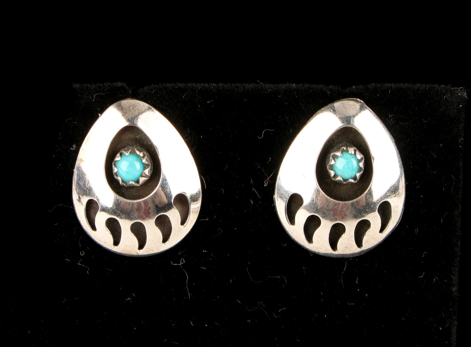 NATIVE AM. BEAR PAW TURQUOISE STERLING EARRINGS: Sterling shadowbox bear paw post earrings set with cabochon turquoise stones. 1/2" $40 - $80 Please contact us for high resolution images of this lot. Shipping: