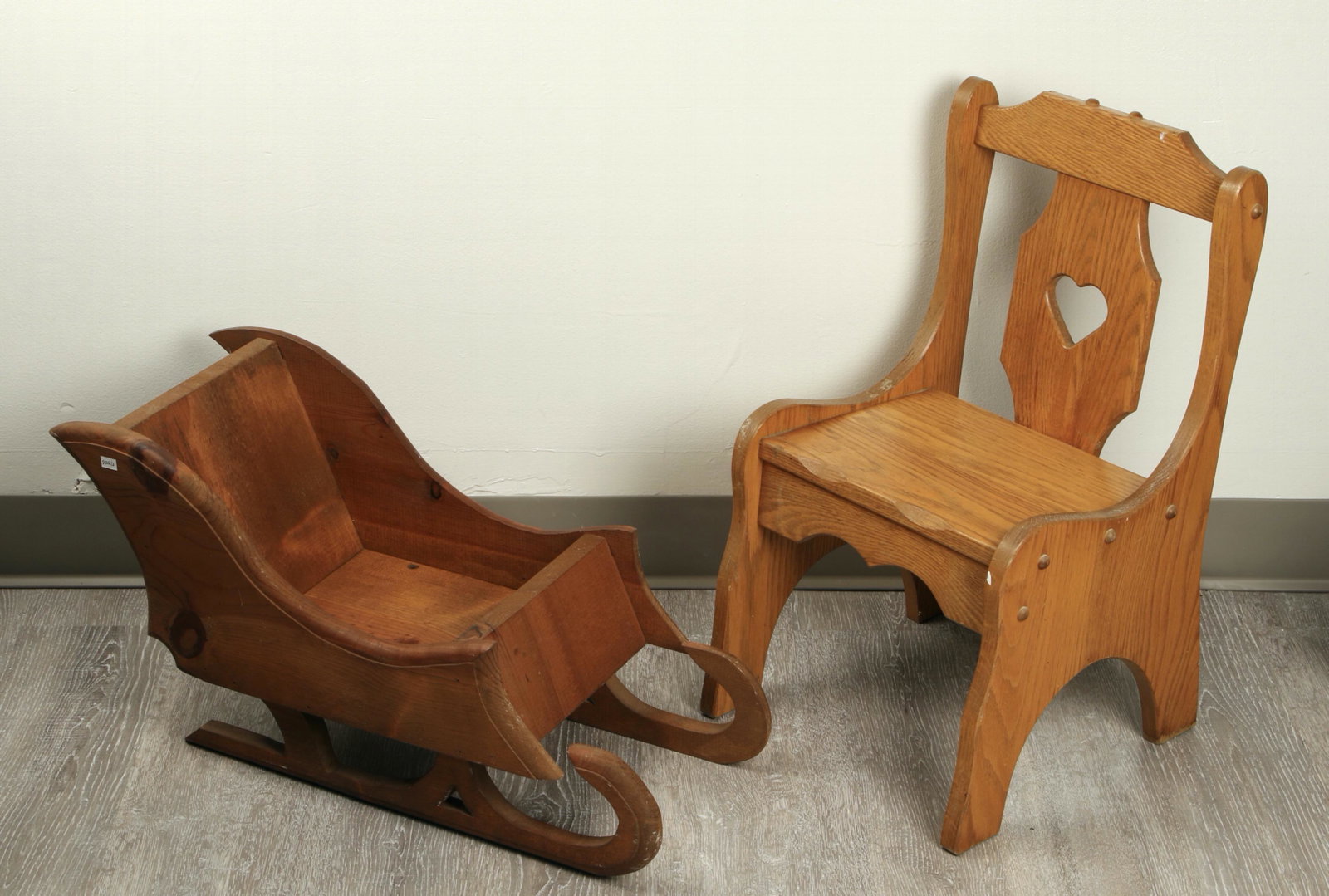 CHILD'S OAK CHAIR AND DISPLAY SLEIGH: Heart shape in back splat of chair. Sleigh has curving sides. $40 - $80 Please contact us for high resolution images of this lot. Shipping: We are unable to ship this item. Please contact a