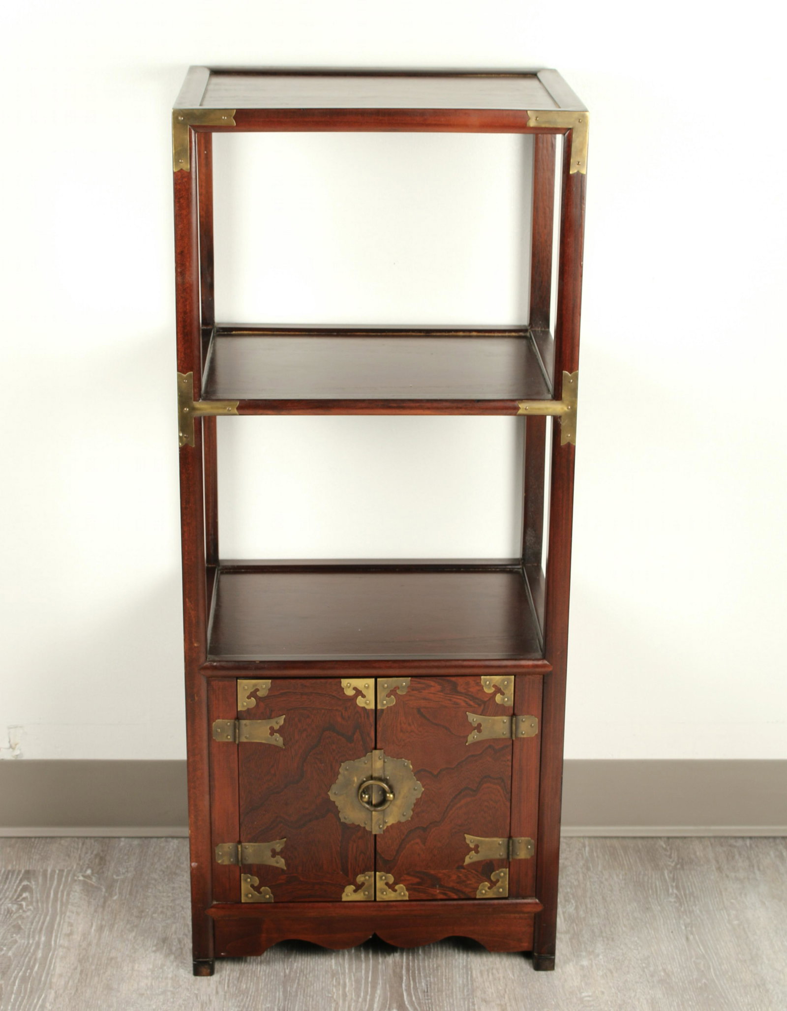 SMALL CHINESE STYLE THREE TIERED SHELF: Narrow cabinet with shelves over a lower cabinet. With brass corners and decorative hardware. Made in Korea. 15 1/2" X 37" $100 - $200 Please contact us for high resolution images of t