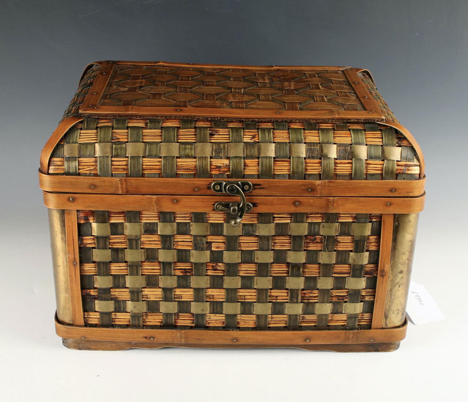 LIDDED WOVEN PICNIC BASKET: Woven with brass accents. Woven handles. Hand made in China. 15 1/2" X 10 1/2" $40 - $80 Please contact us for high resolution images of this lot. Shipping: