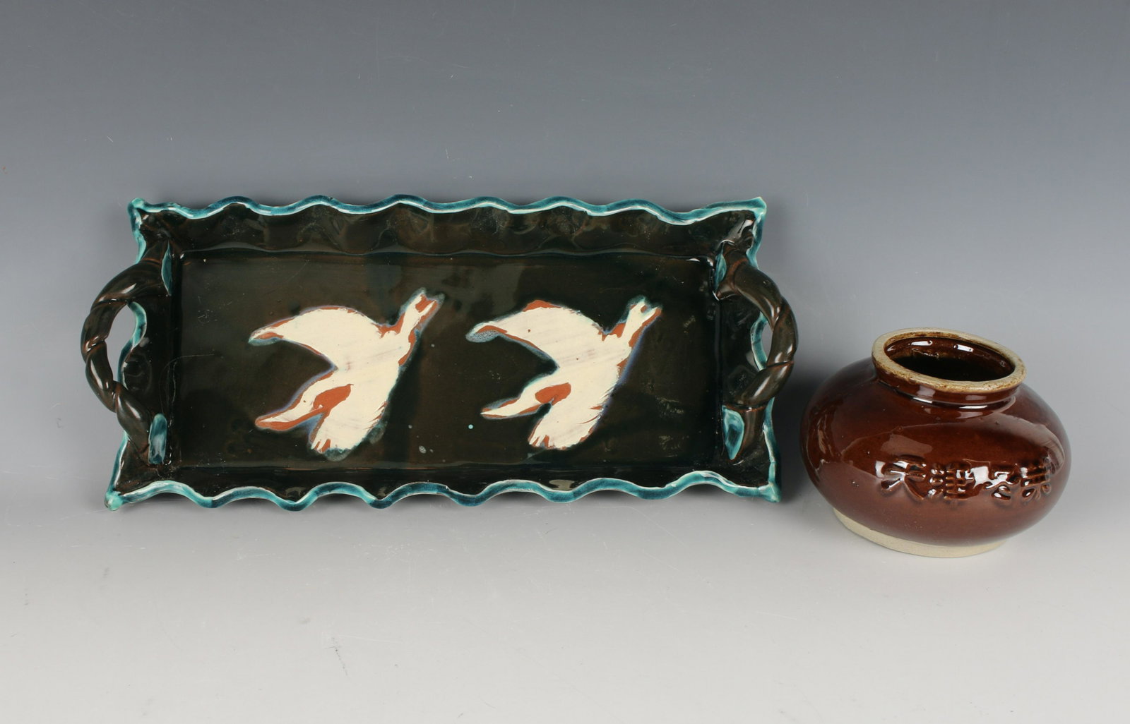 ART POTTERY CRANE TRAY & BEAN POT: Art pottery crane tray and ceramic bean pot. Tray has applied rope handles and scalloped edge. Signed on bottom. 12" X 14 1/2" $40 - $80 Please contact us for high resolution images o