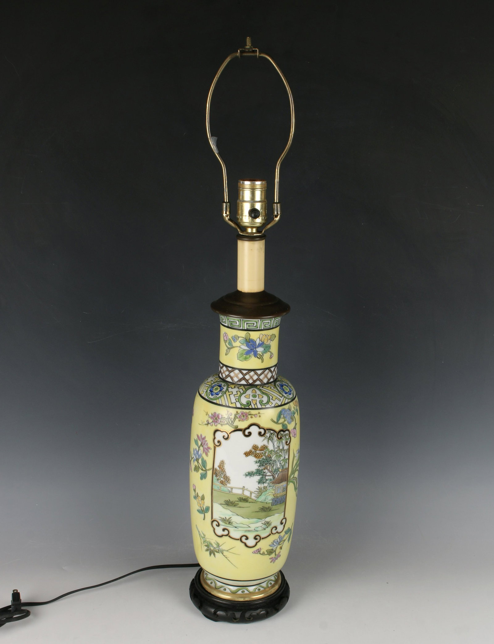 TALL CHINESE PORCELAIN VASE LAMP: Yellow background with a village reserve on each side. The neck has a meander border above a floral reserve above a diapered pattern. On custom wooden stand. With harp. 5" X 28" $100 - $2