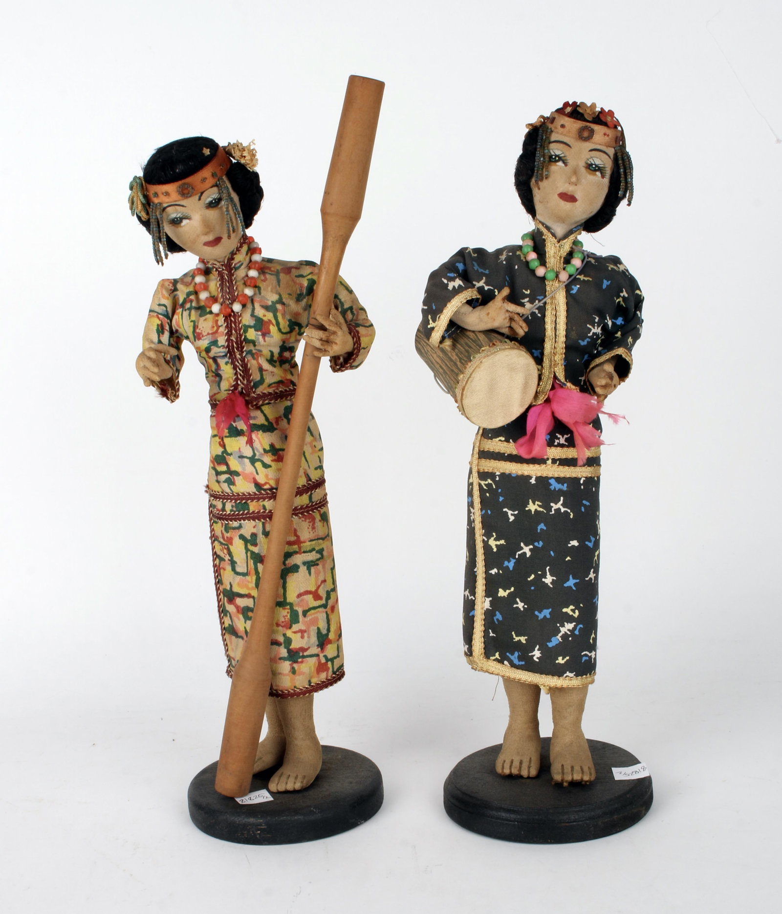 TWO TAIWANESE NATIVE DOLLS: Both are wearing traditional dress with headdresses, and holding instruments. 14" $40 - $80 Please contact us for high resolution images of this lot. Shipping:
