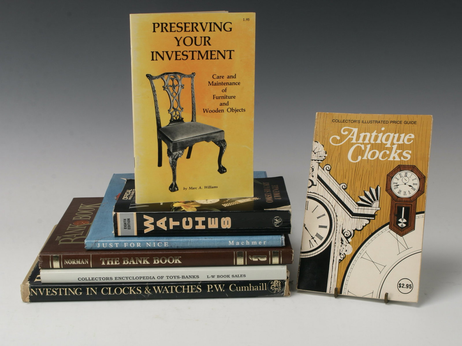 7 PRICE/REFERENCE GUIDES CLOCKS, WATCHES, BANKS: Included in this lot Collector's Illustrated Price Guide to Antique Clocks 1977, Preserving Your Investment 1983, Official Price Guide to Watches 1988, Just For Nice 1991, The Bank Book 1984, Collecto