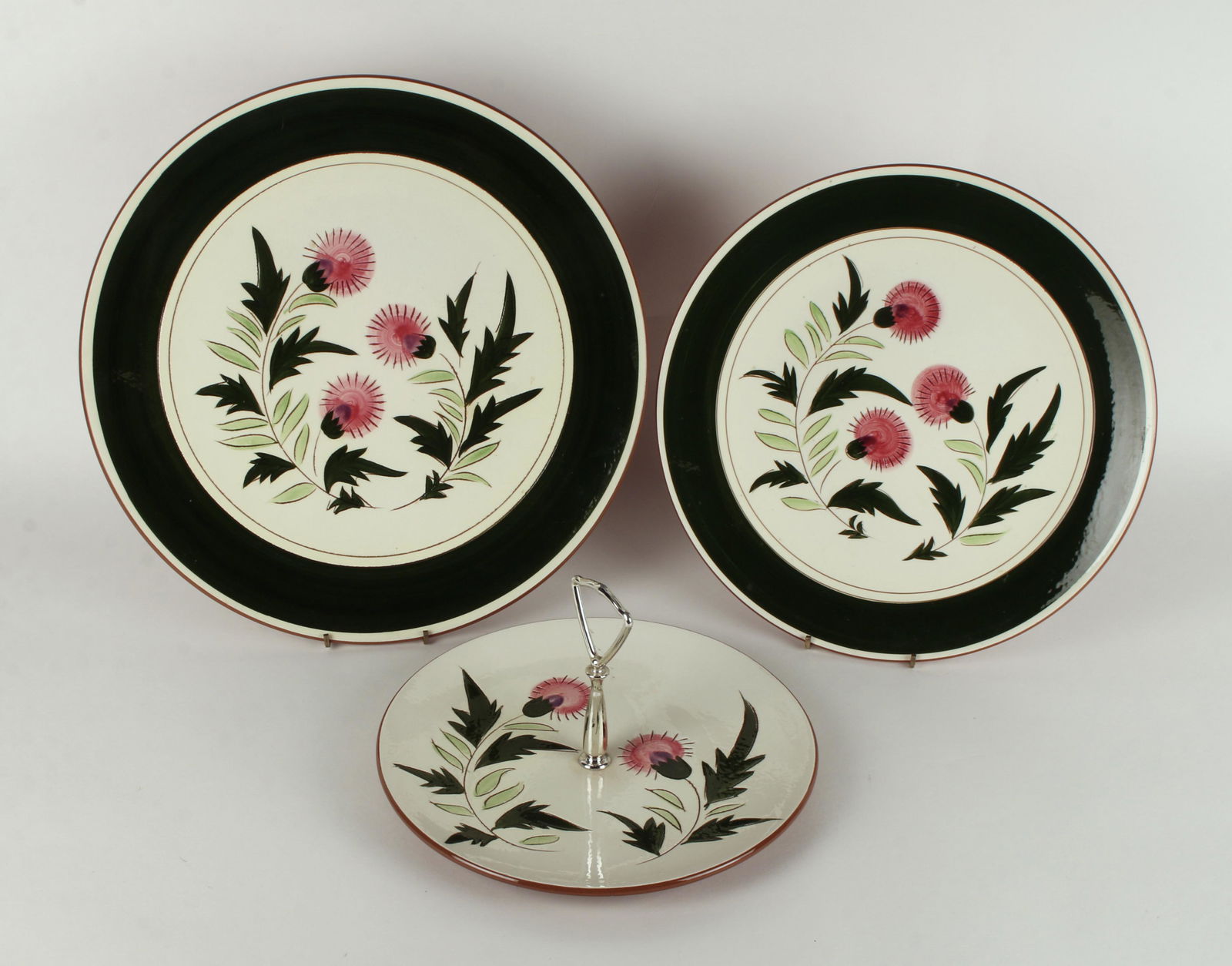 3 RARE THISTLE STANGL SERVING PLATTERS 14 1/4": Two large round serving platters and a dessert plate with handle. 14 1/4" & 12 1/2" $200 - $400 Please contact us for high resolution images of this lot. Shipping: <