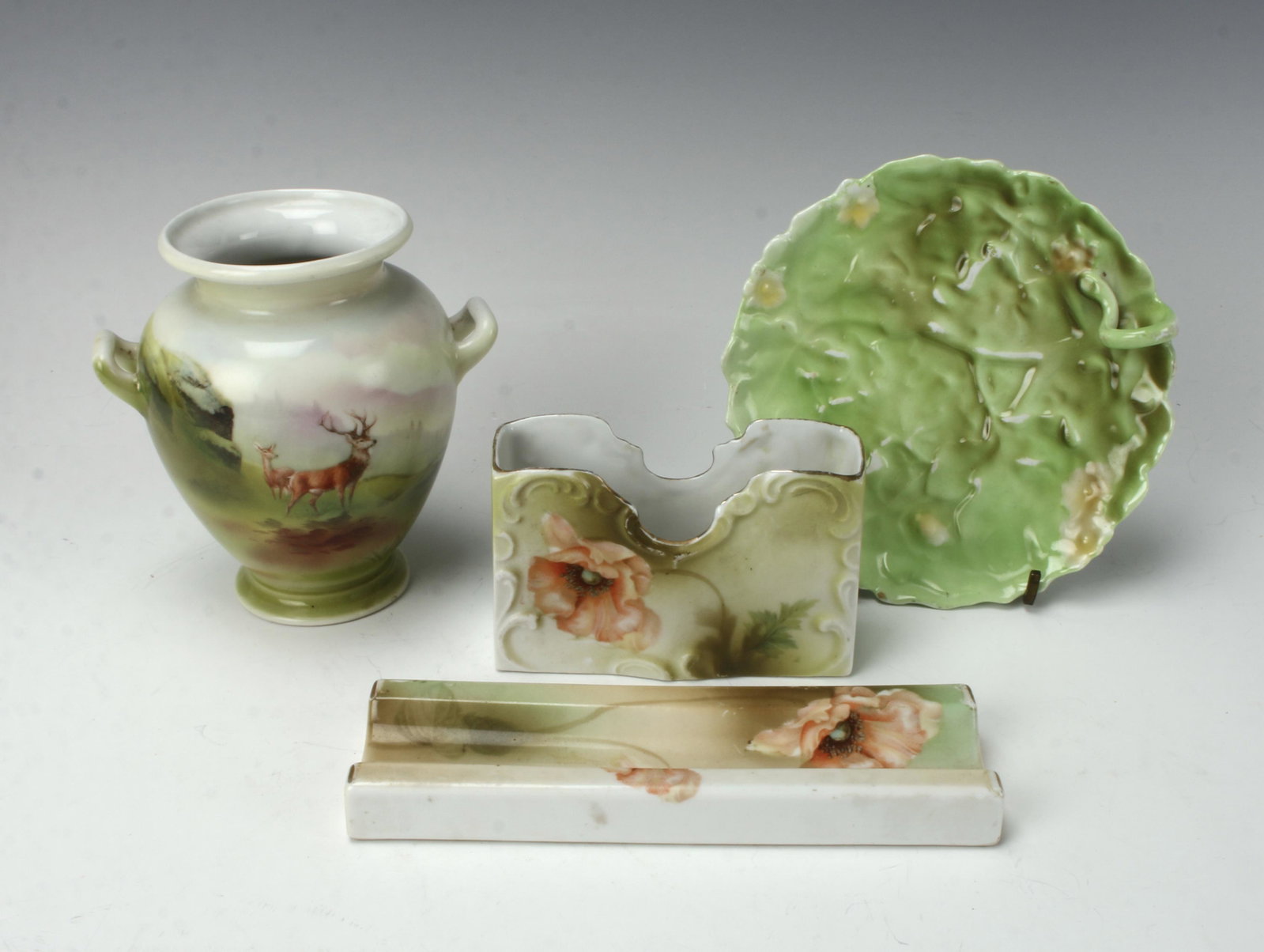 ASSEMBLED LOT 4 ROYAL BAYREUTH GERMAN PORCELAIN: Royal Bayreuth marked handled vase, pin tray. Vase is handled and painted with scenes of deer in the woods. Hand painted poppy pattern desk set letter/card holder, and pen holder marked Germany. 5 1/2