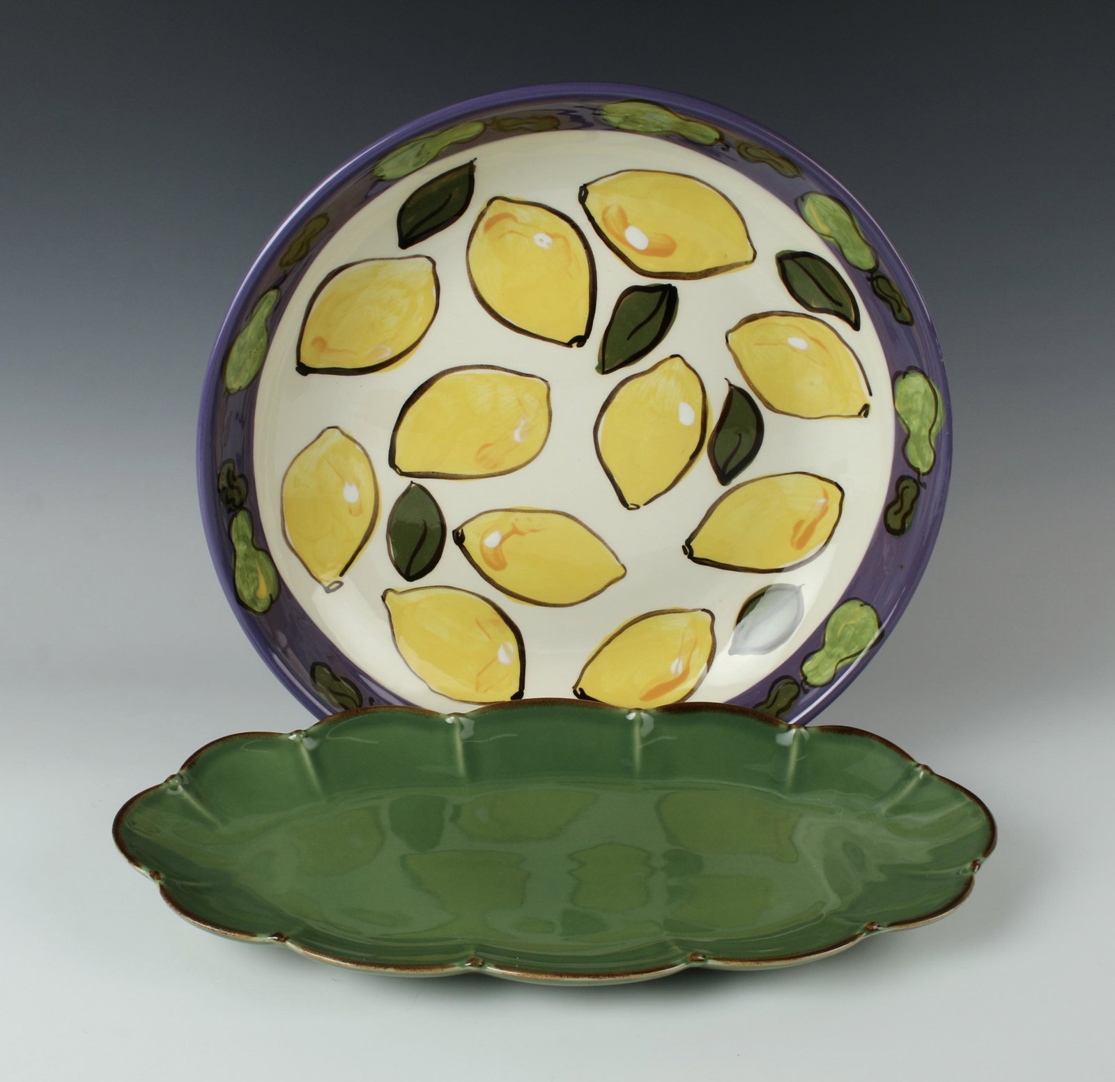 PAULA ESTEY SIGNED SERVING BOWL & W.H. DISH: Paula Estey signed serving bowl decorated in lemons and a border of green pears. W.H. made in Portugal serving dish. Stand not included. 13 1/2" X 2 3/4" $100 - $200 Please contact us
